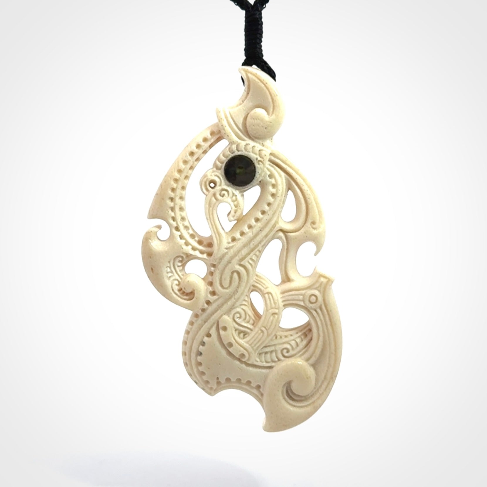 This is a wonderful, finely carved Manaia pendant. It is hand carved by Andrew Doughty and we will ship it to you free anywhere in the world. Hand made from whale bone and delivered to you with an adjustable black cord. Packaged in a woven kete pouch.