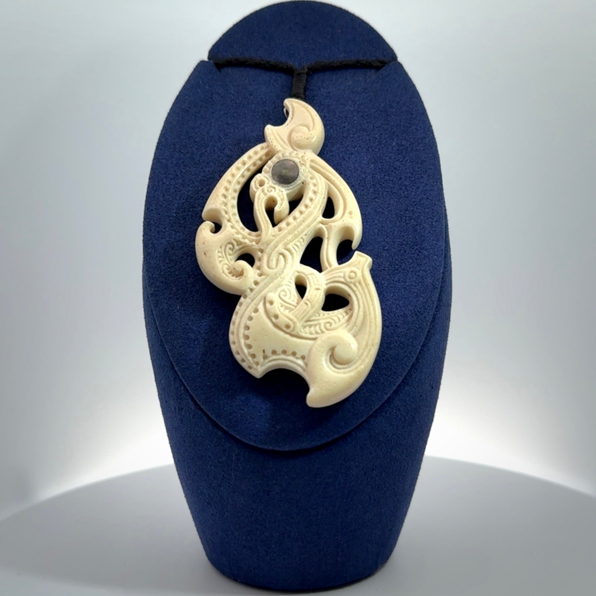 This is a wonderful, finely carved Manaia pendant. It is hand carved by Andrew Doughty and we will ship it to you free anywhere in the world. Hand made from whale bone and delivered to you with an adjustable black cord. Packaged in a woven kete pouch.