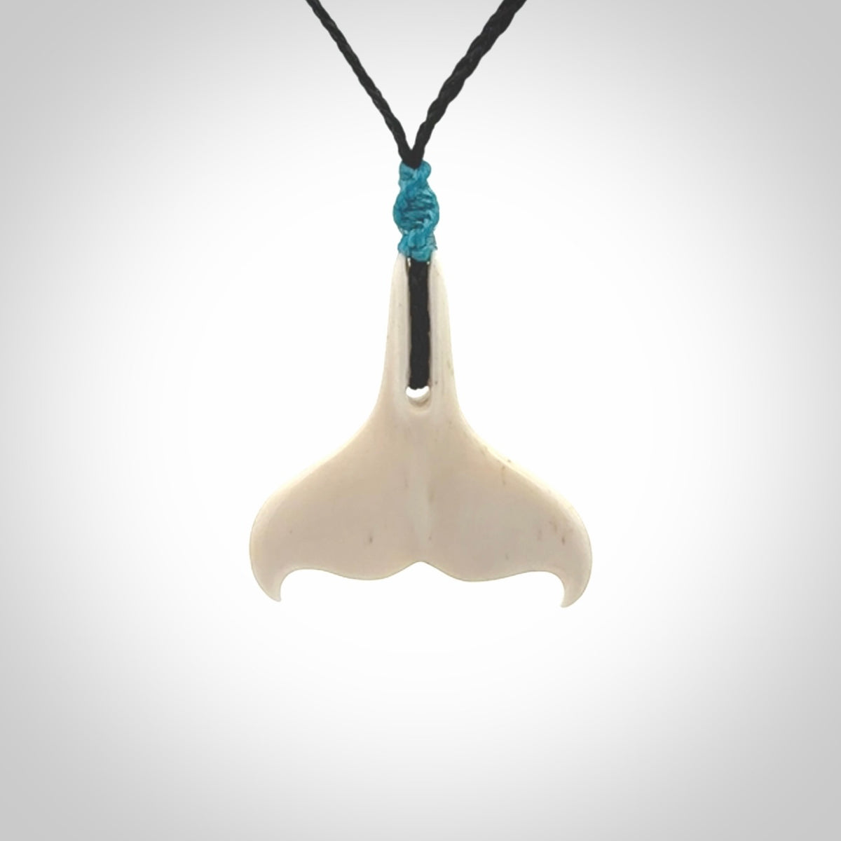 Hand carved bone whale tail pendant. Unisex necklace hand carved by Andrew Doughty here in New Zealand. Unique art to wear. Delivered with an adjustable black cord.