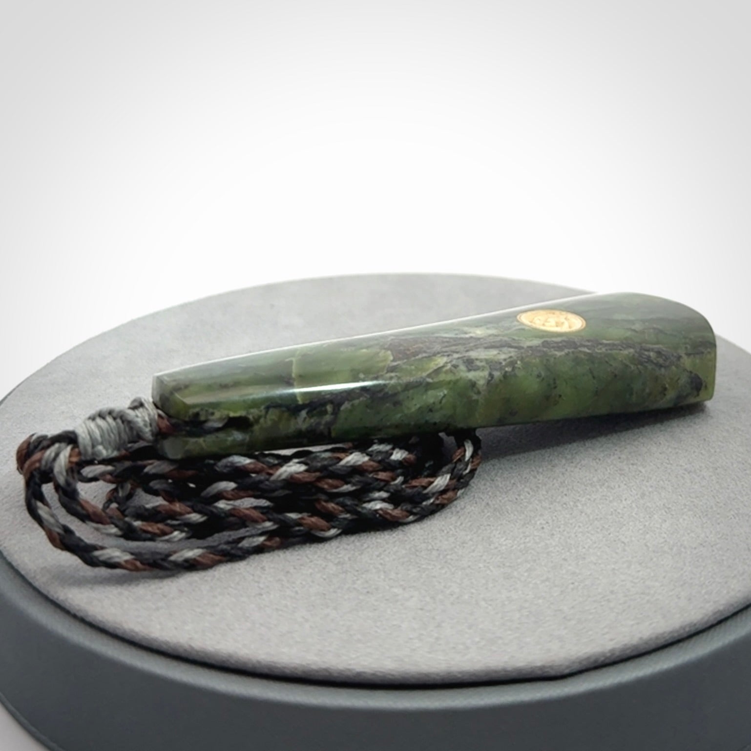 Hand carved New Zealand Jade drop pendant with whale bone koru inlay