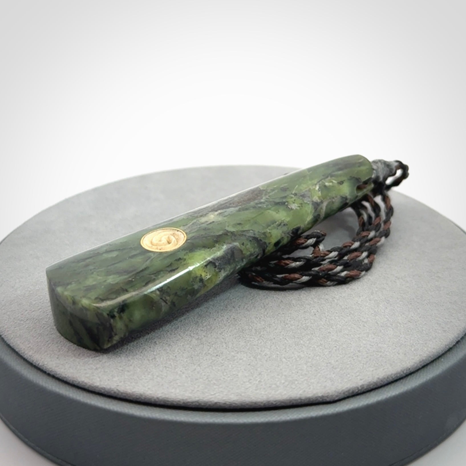 Hand carved New Zealand Jade drop pendant with whale bone koru inlay