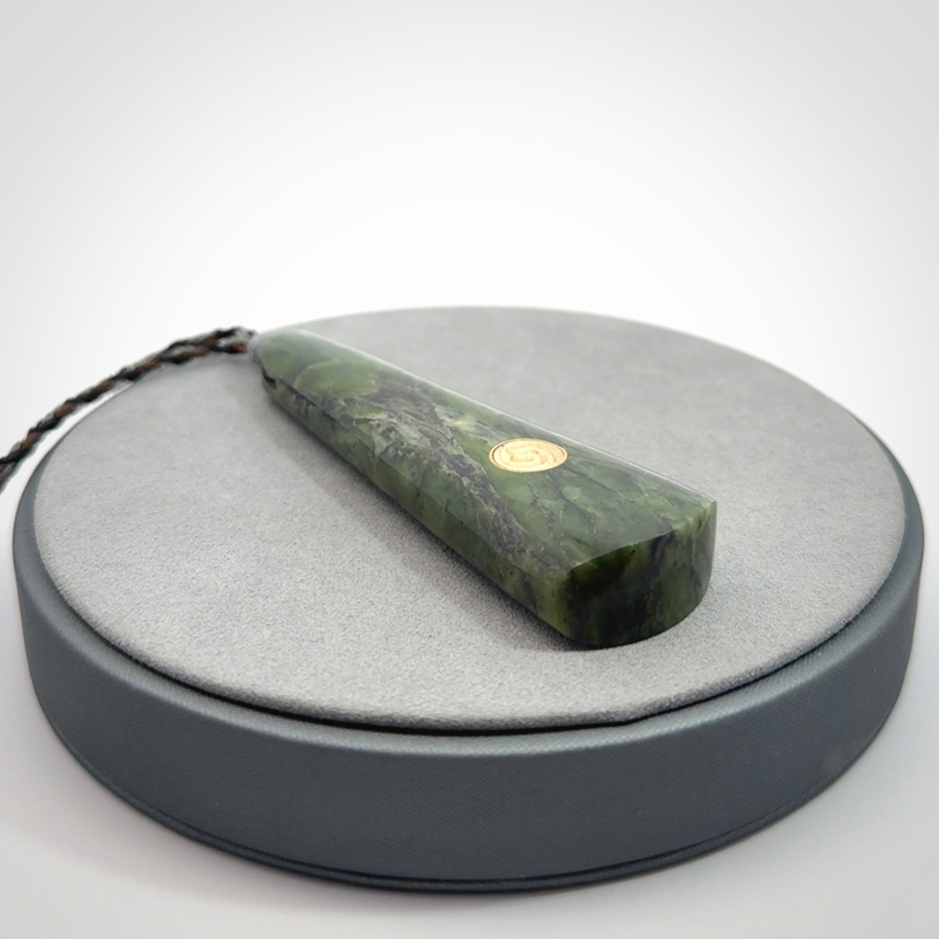Hand carved New Zealand Jade drop pendant with whale bone koru inlay