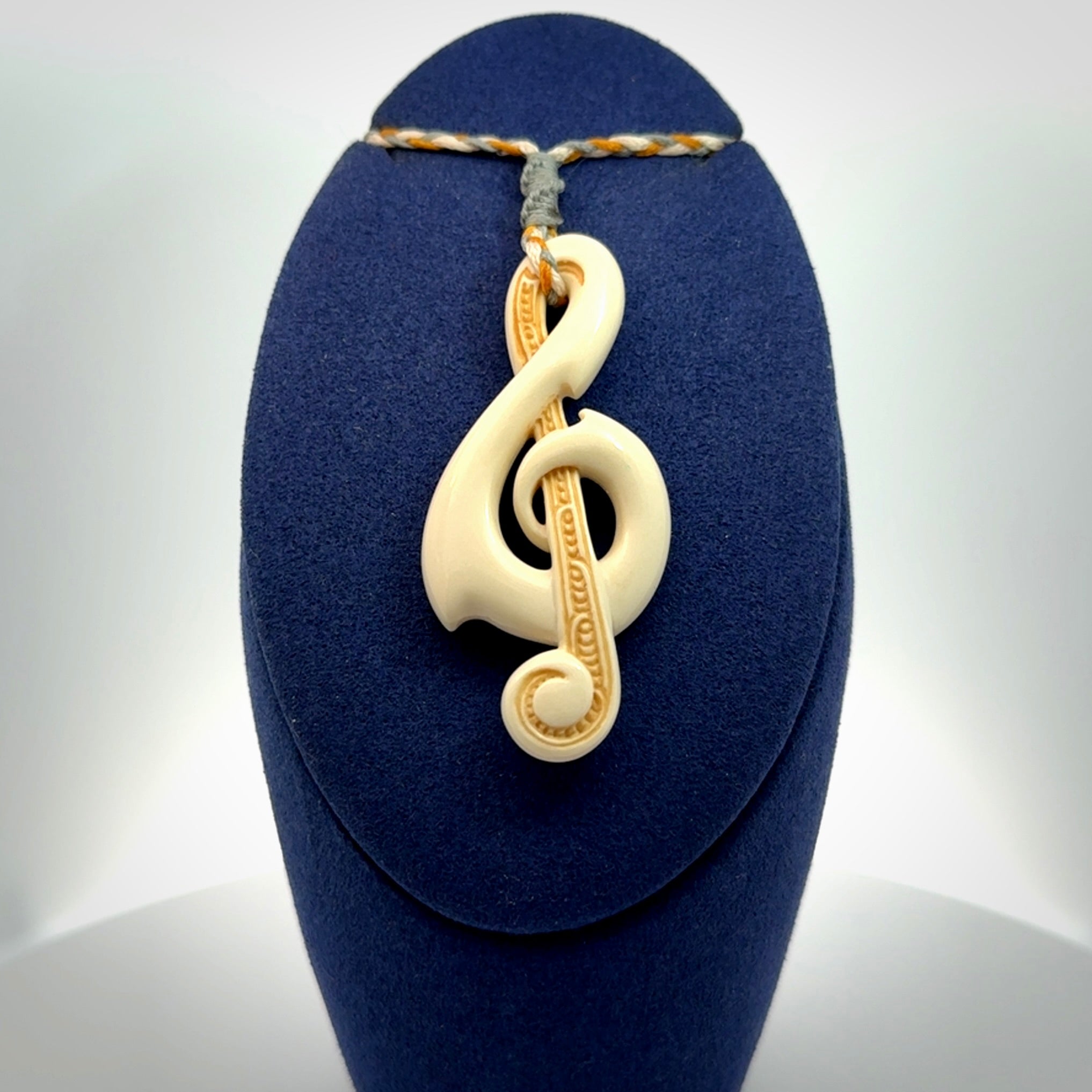 A Beautifully Carved Treble Clef Pendant in Bone