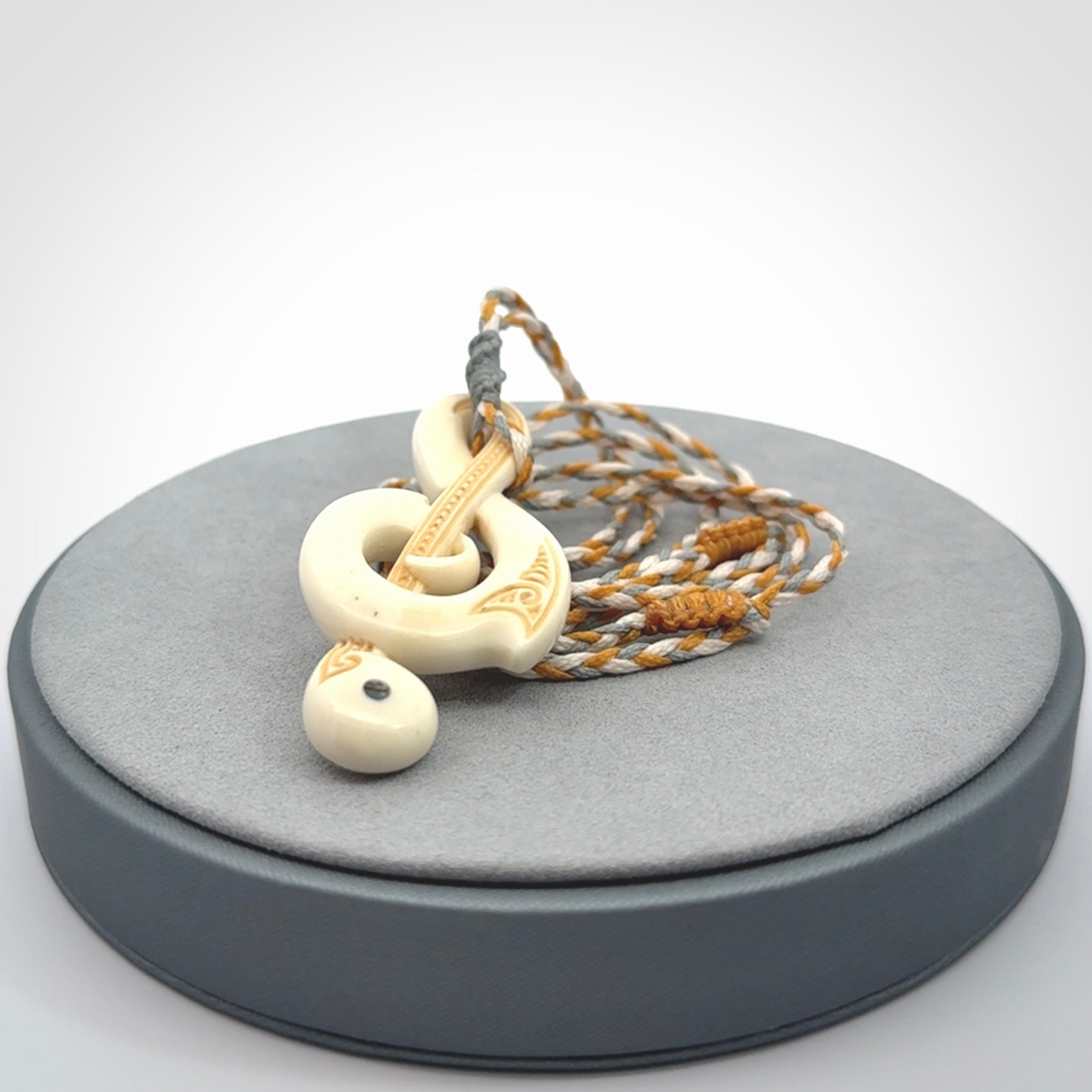 A Beautifully Carved Treble Clef Pendant in Bone