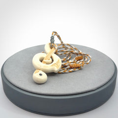 A Beautifully Carved Treble Clef Pendant in Bone