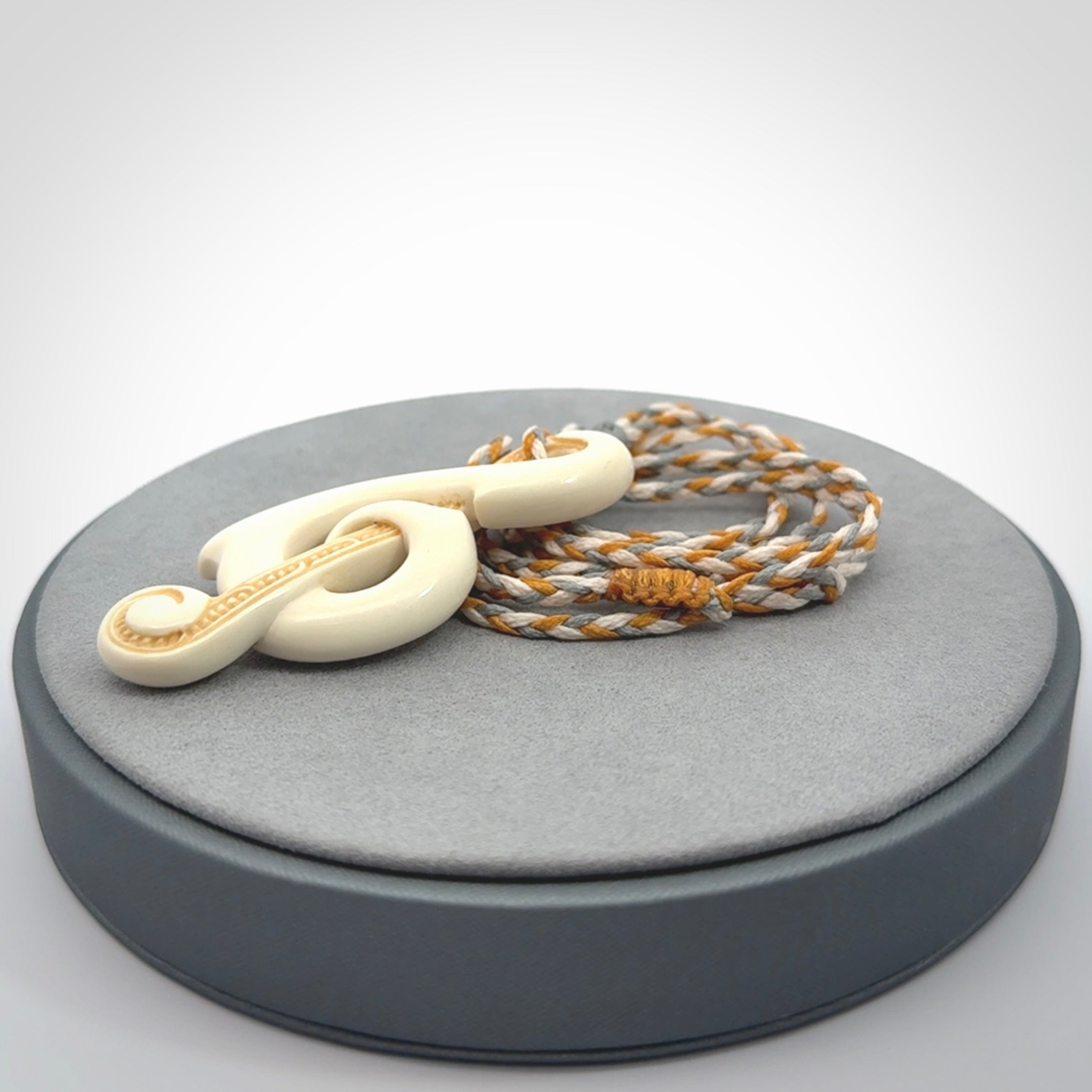A Beautifully Carved Treble Clef Pendant in Bone