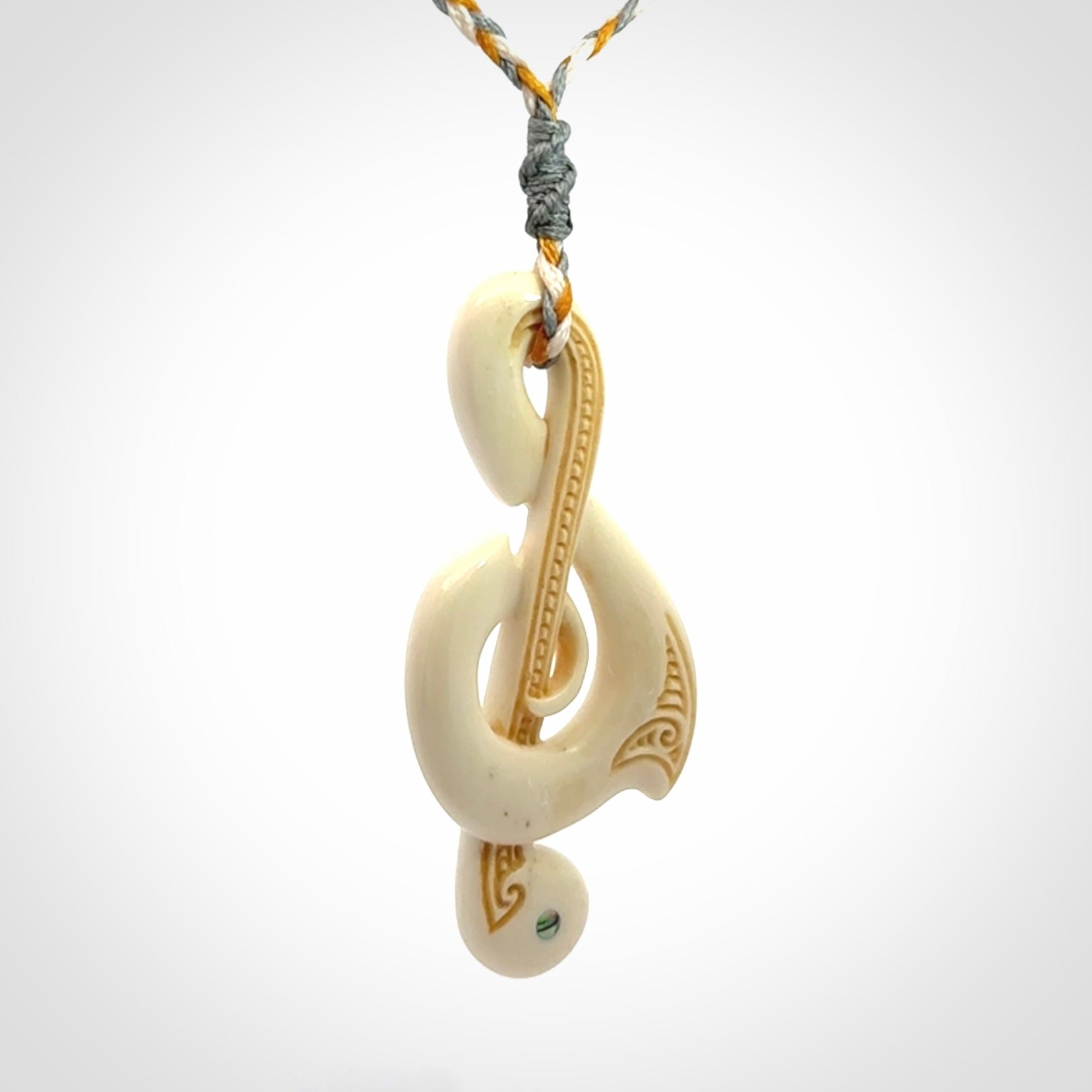 A Beautifully Carved Treble Clef Pendant in Bone