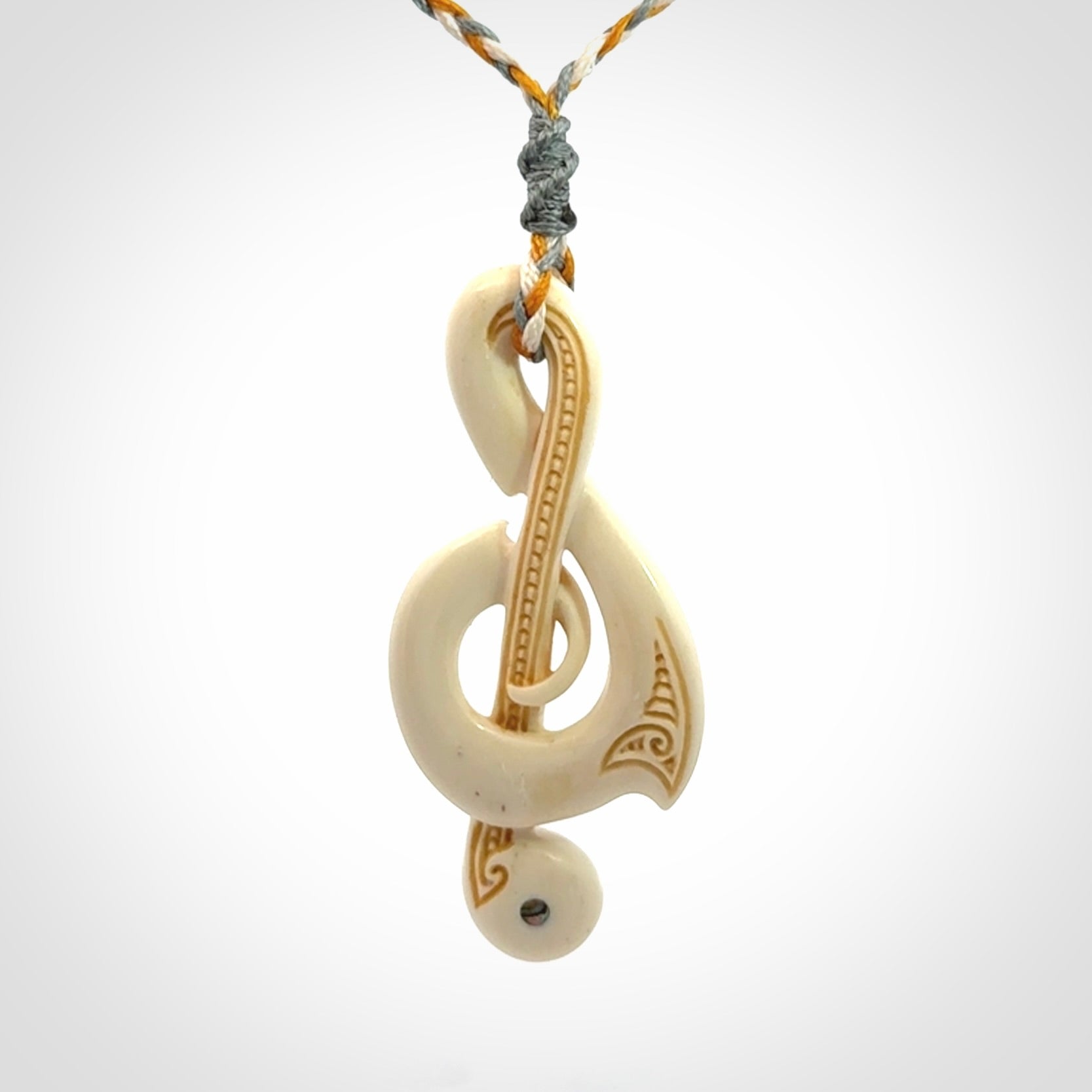 A Beautifully Carved Treble Clef Pendant in Bone