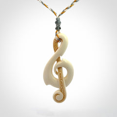A Beautifully Carved Treble Clef Pendant in Bone