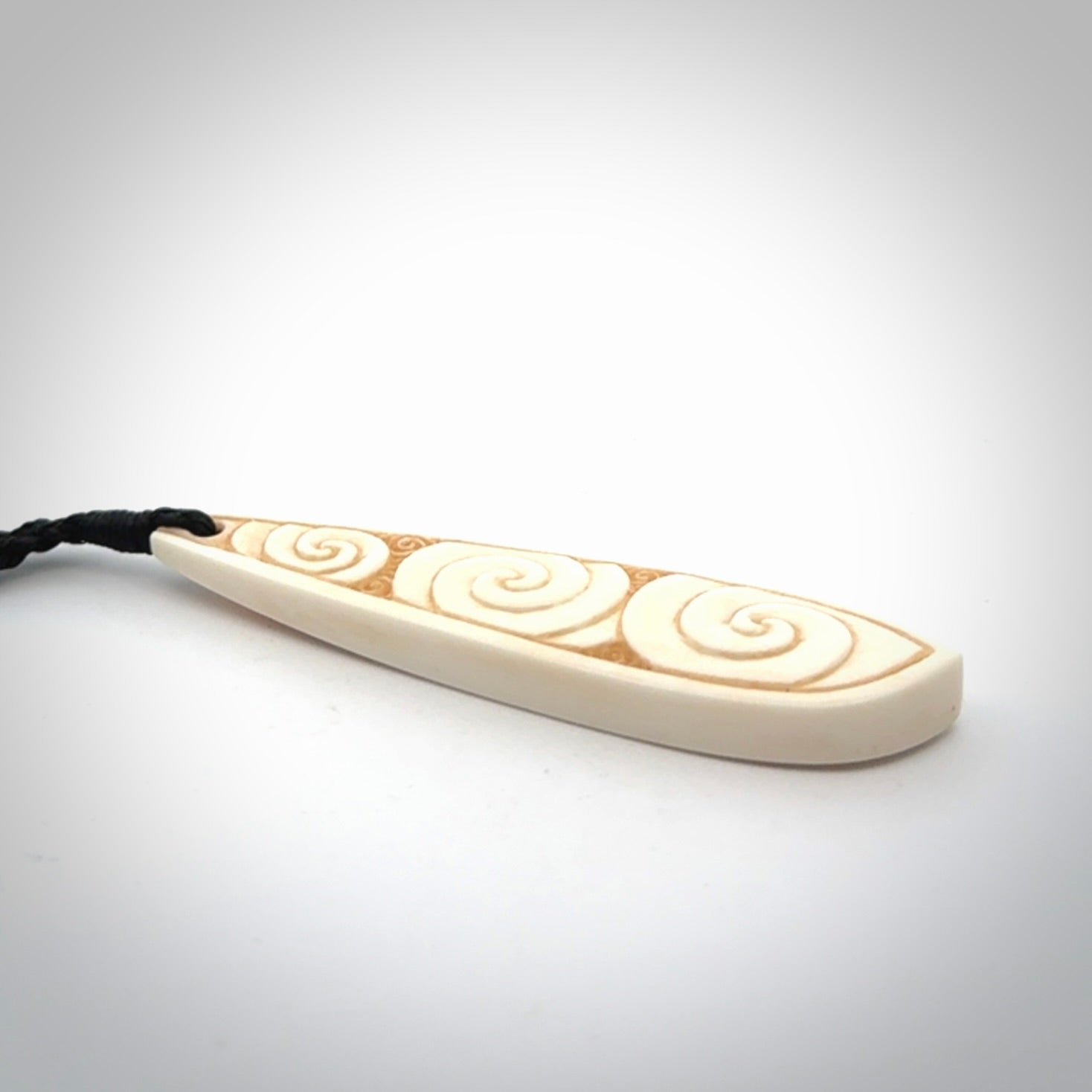 This is a wonderful, finely carved bone drop pendant.