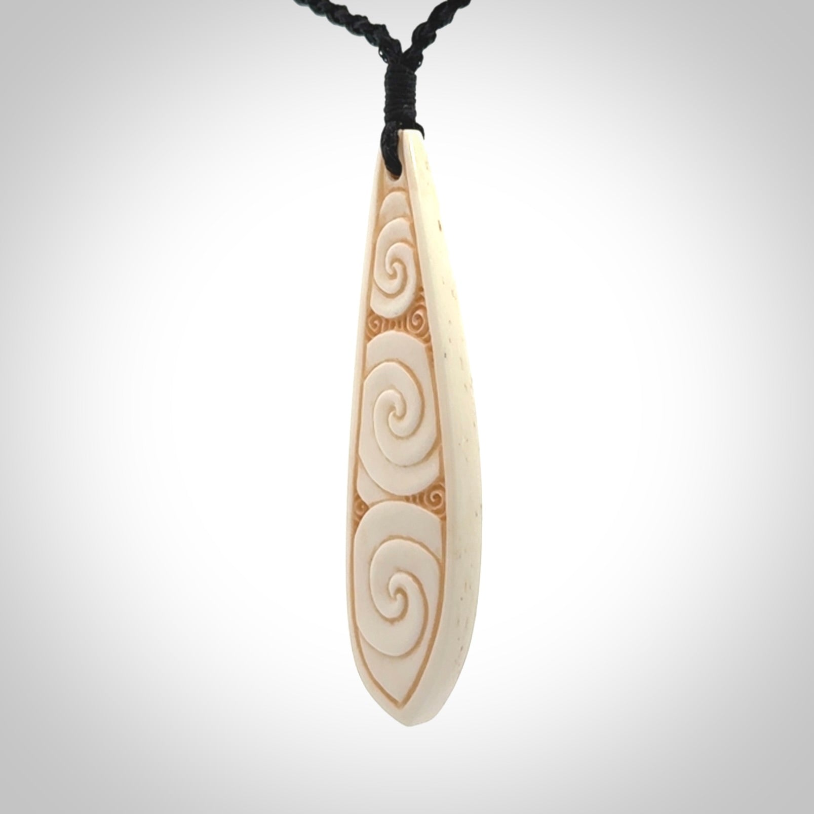 This is a wonderful, finely carved bone drop pendant.