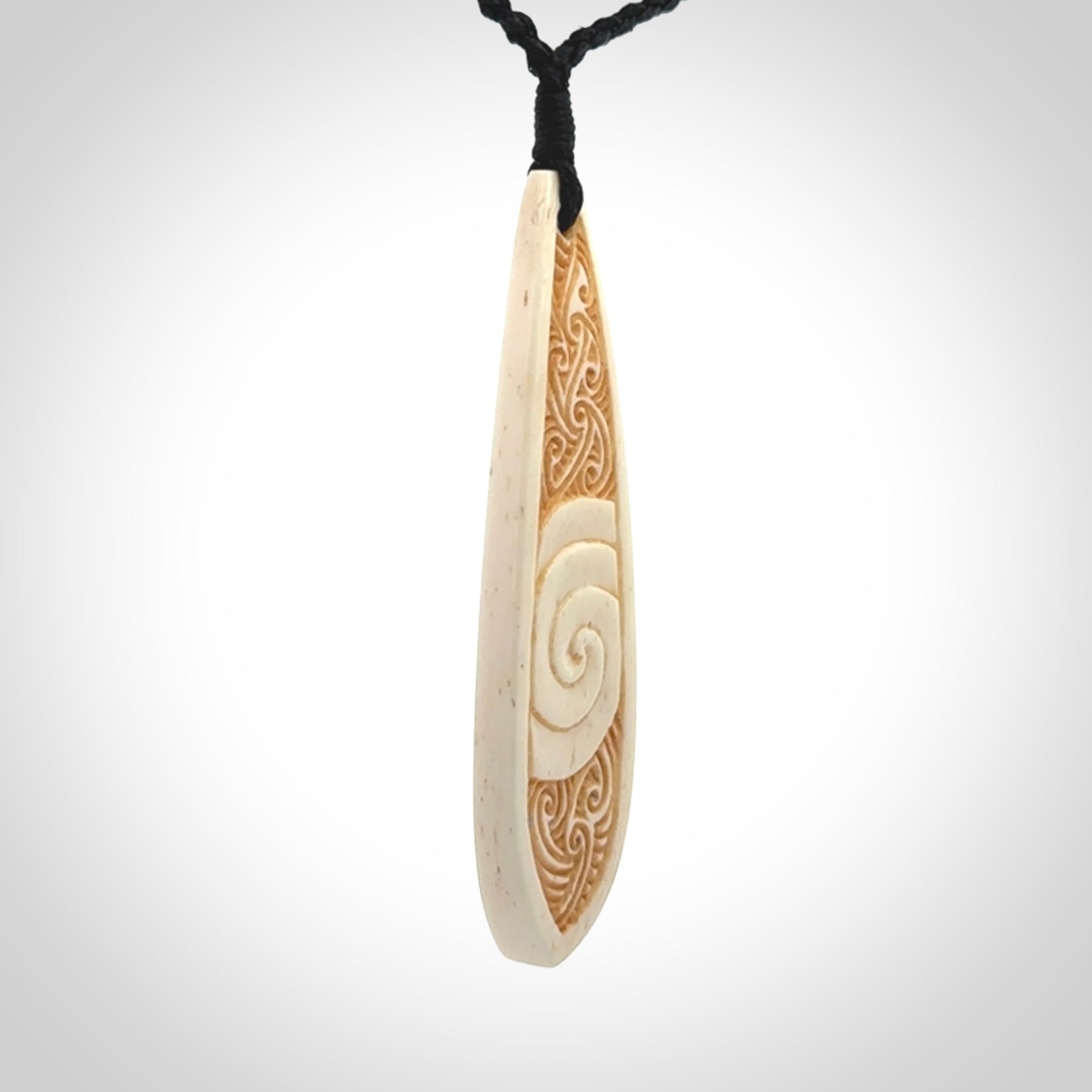 This is a wonderful, finely carved bone drop pendant.