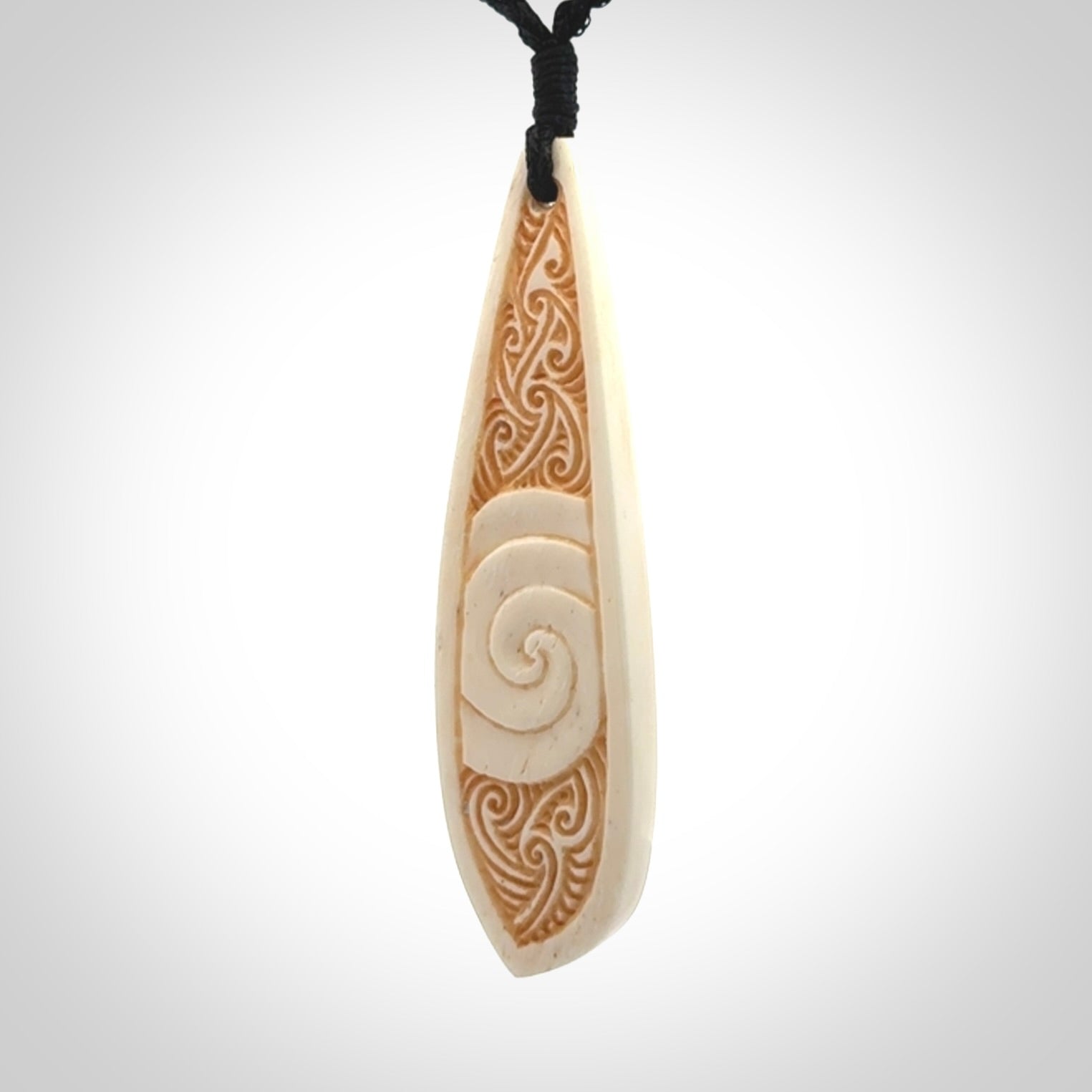 This is a wonderful, finely carved bone drop pendant.