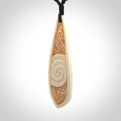 This is a wonderful, finely carved bone drop pendant.