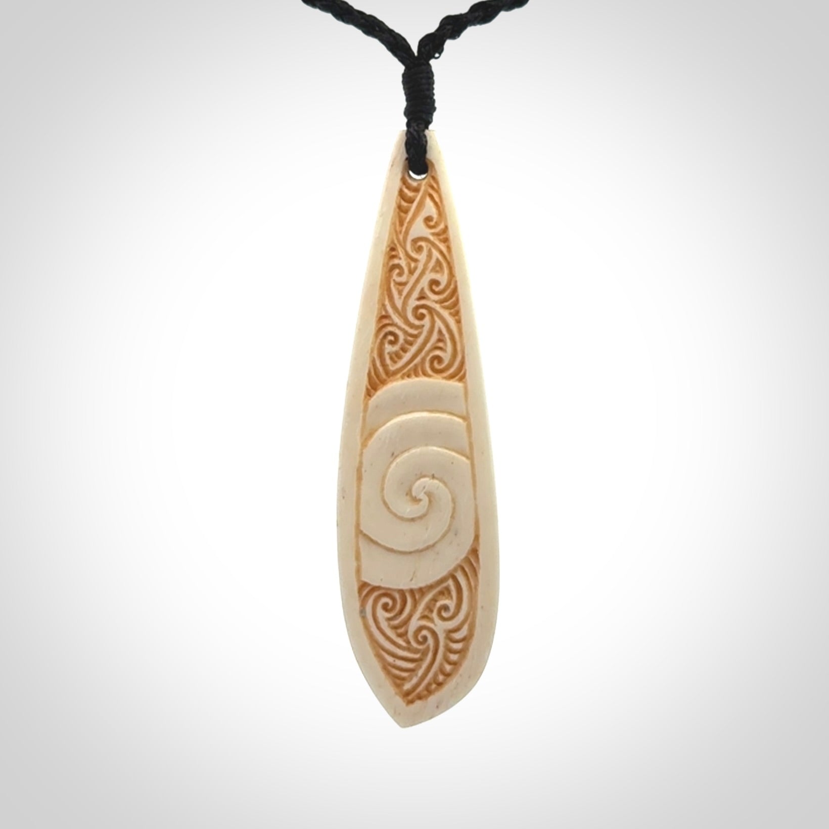 This is a wonderful, finely carved bone drop pendant.