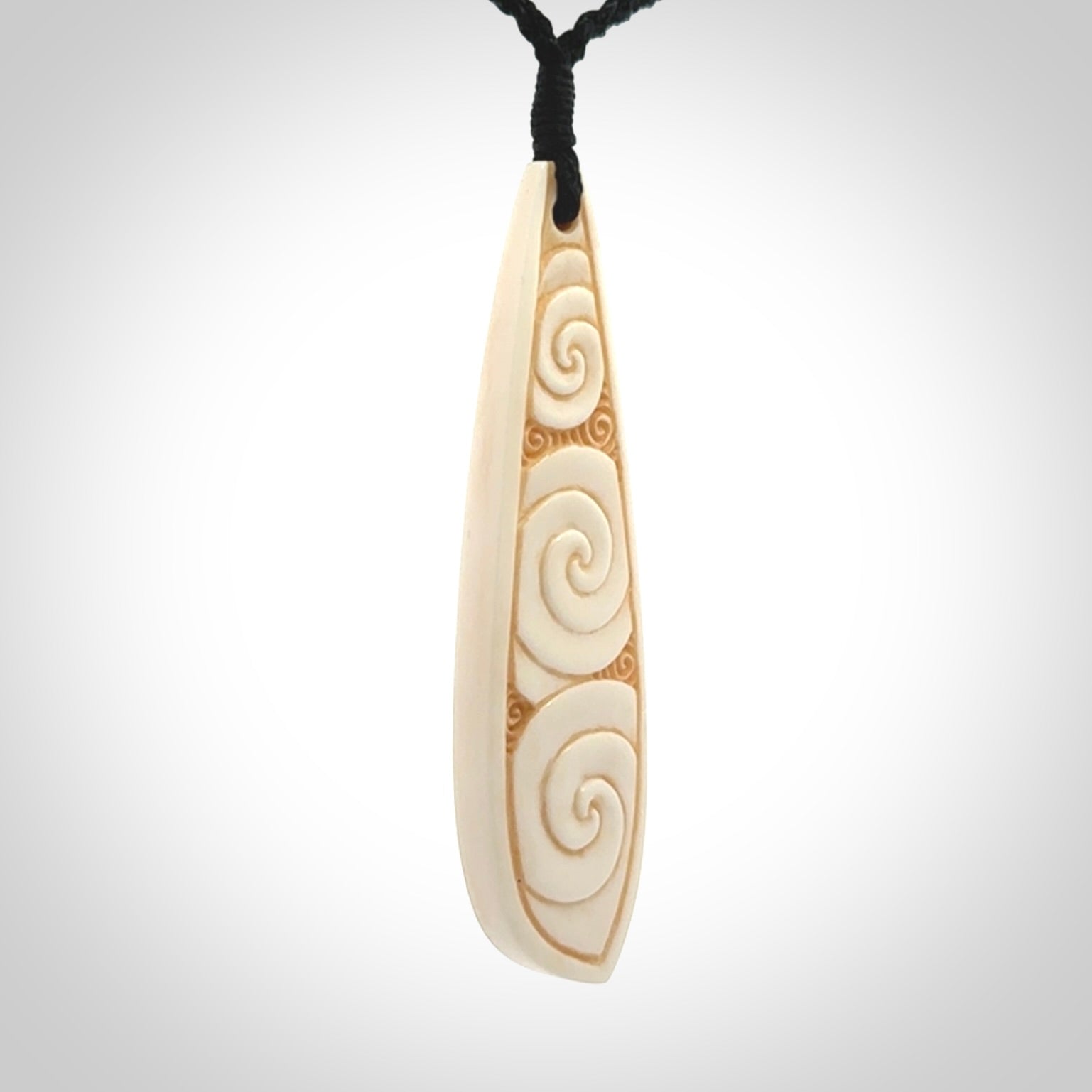 This is a wonderful, finely carved bone drop pendant.