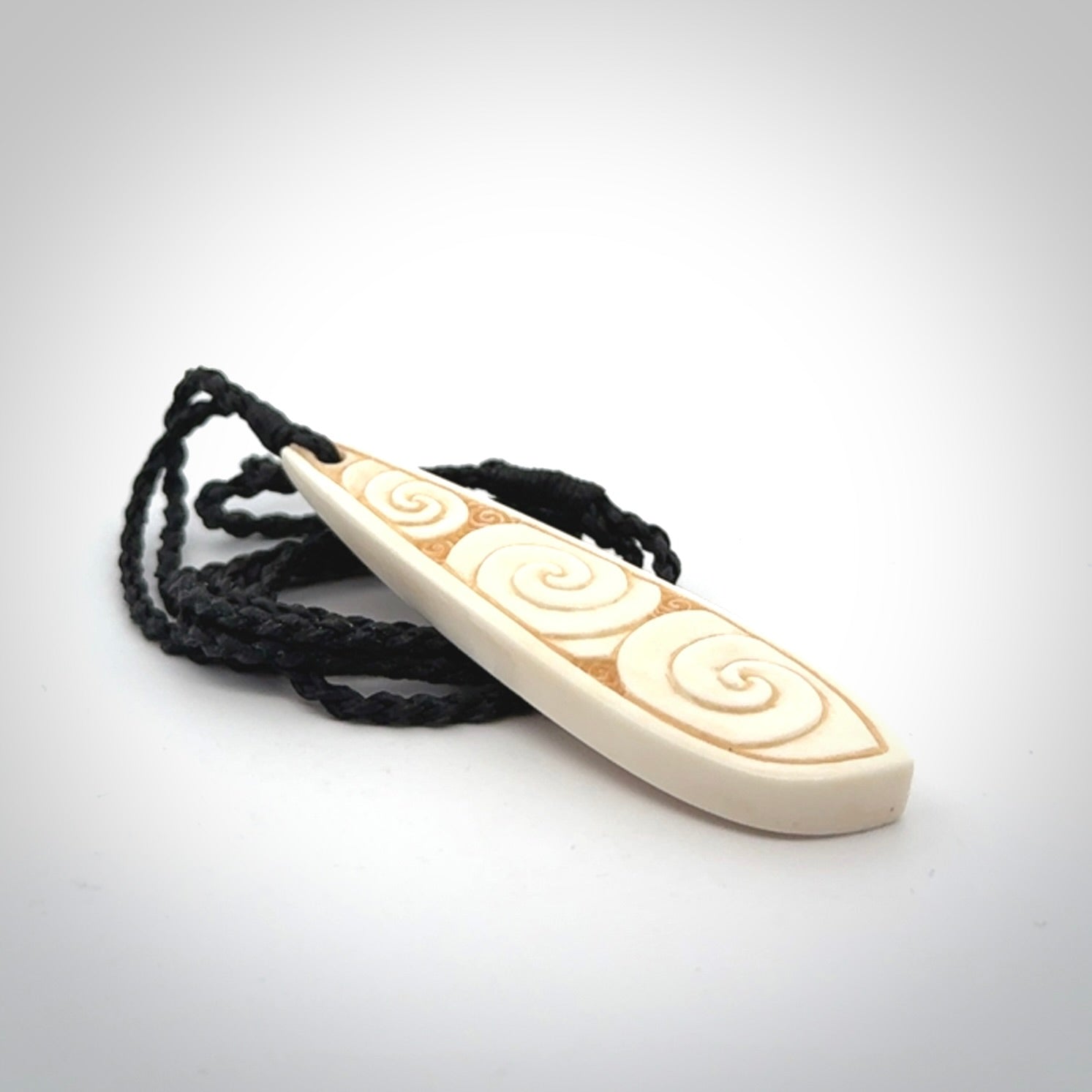 This is a wonderful, finely carved bone drop pendant.