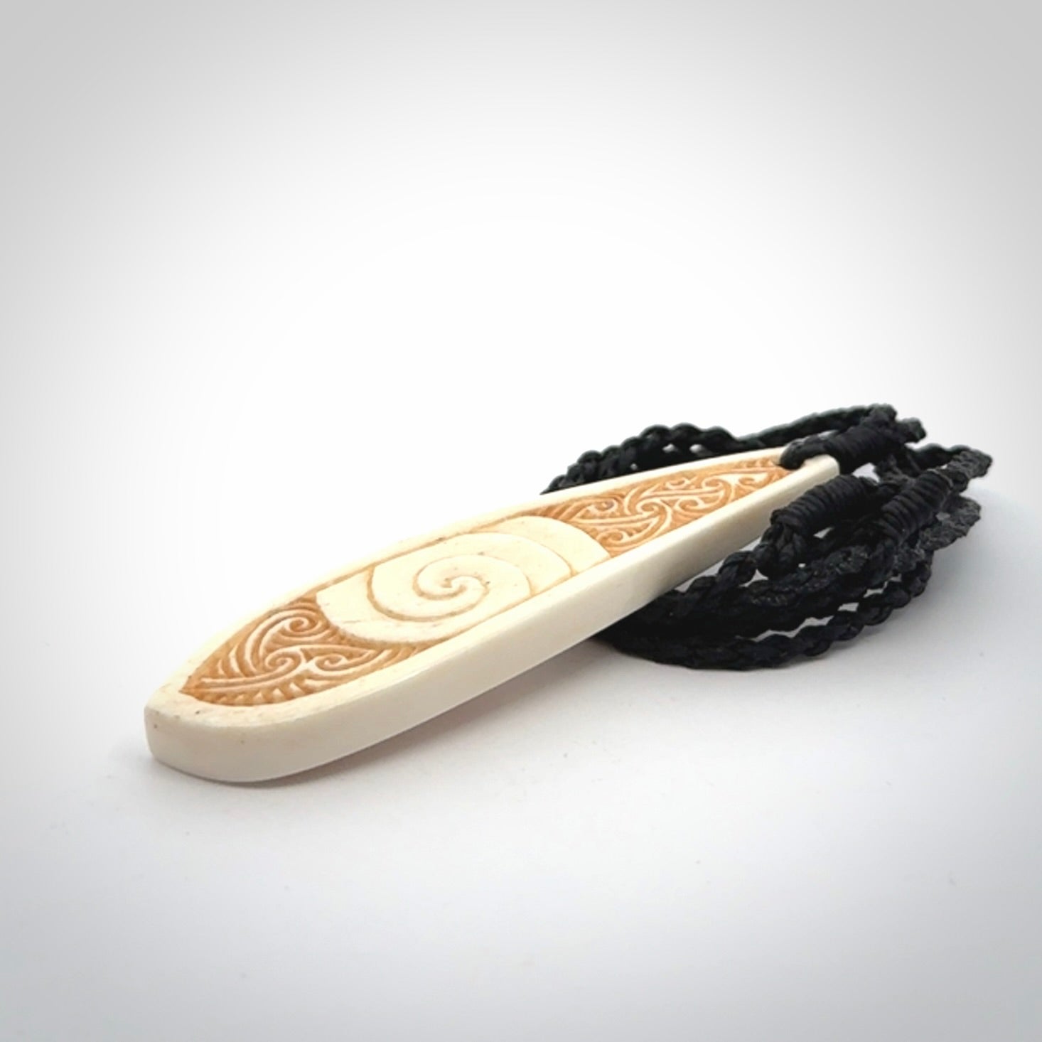This is a wonderful, finely carved bone drop pendant.