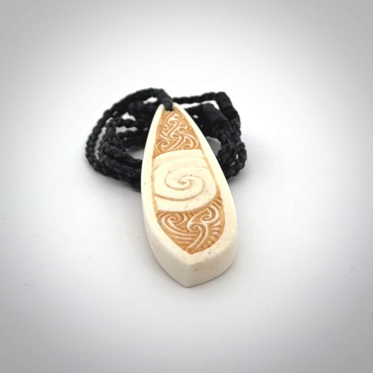 This is a wonderful, finely carved bone drop pendant.