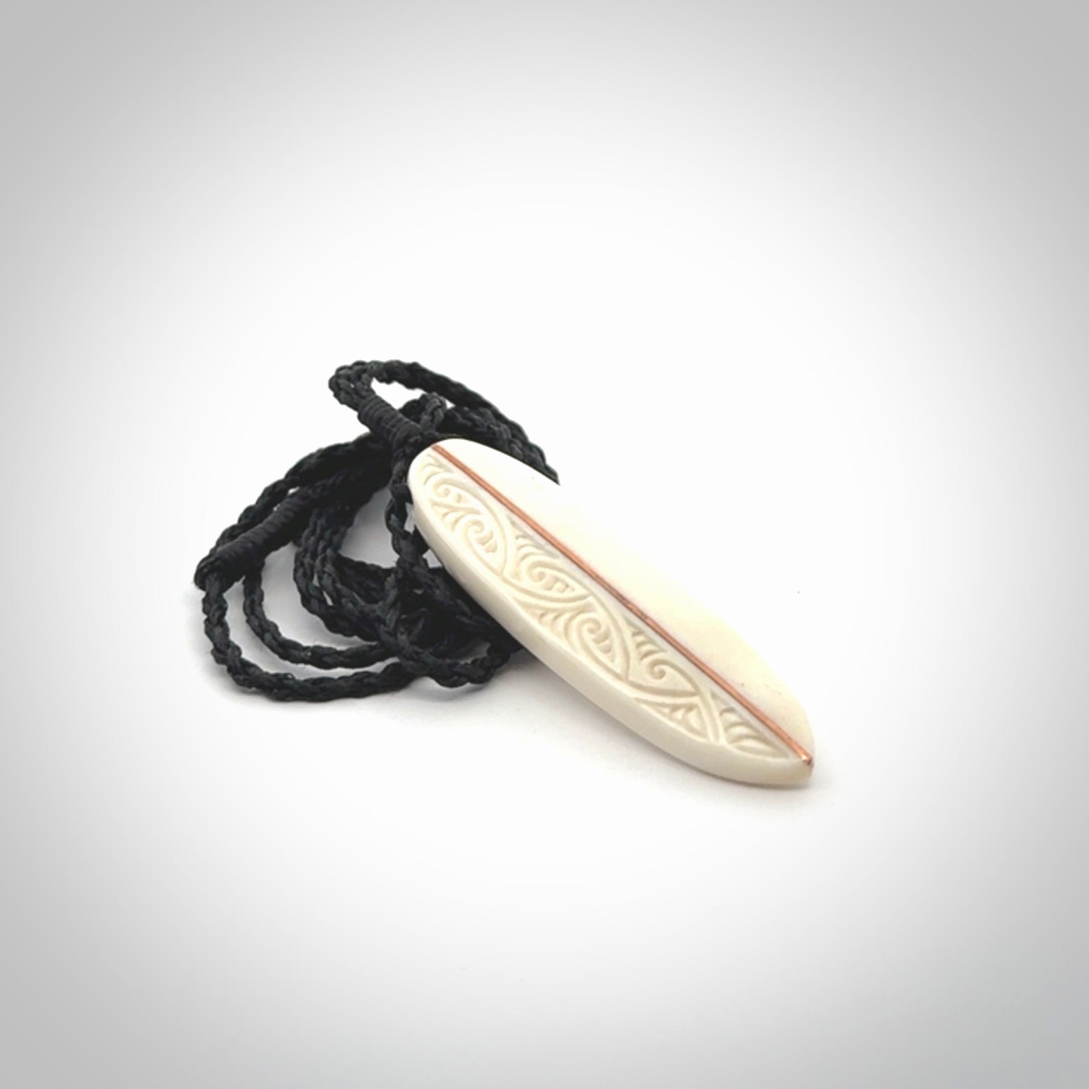 This is a wonderful, finely carved drop pendant. Hand made from bone with copper inlay and delivered to you with an adjustable black cord.