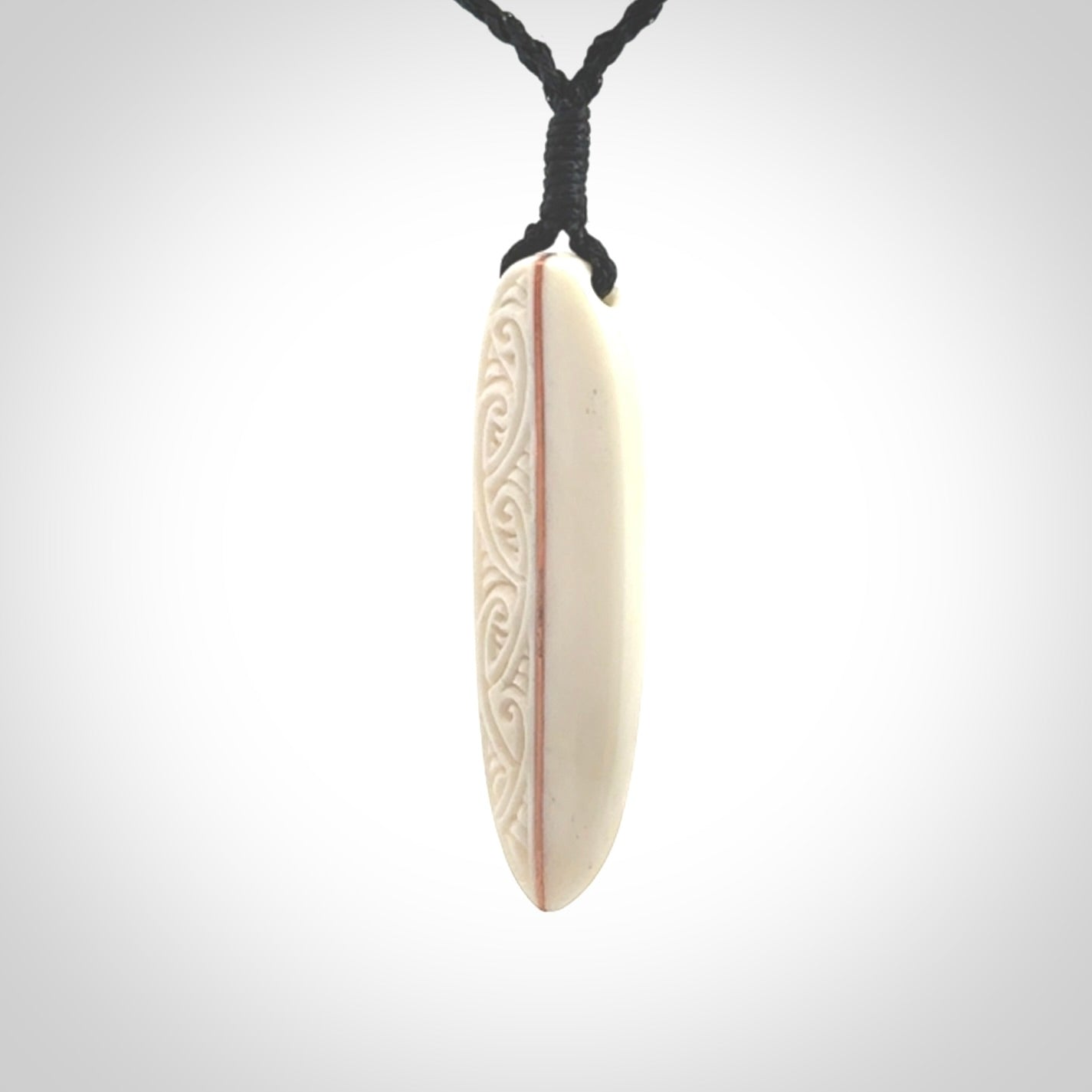 This is a wonderful, finely carved drop pendant. Hand made from bone with copper inlay and delivered to you with an adjustable black cord.