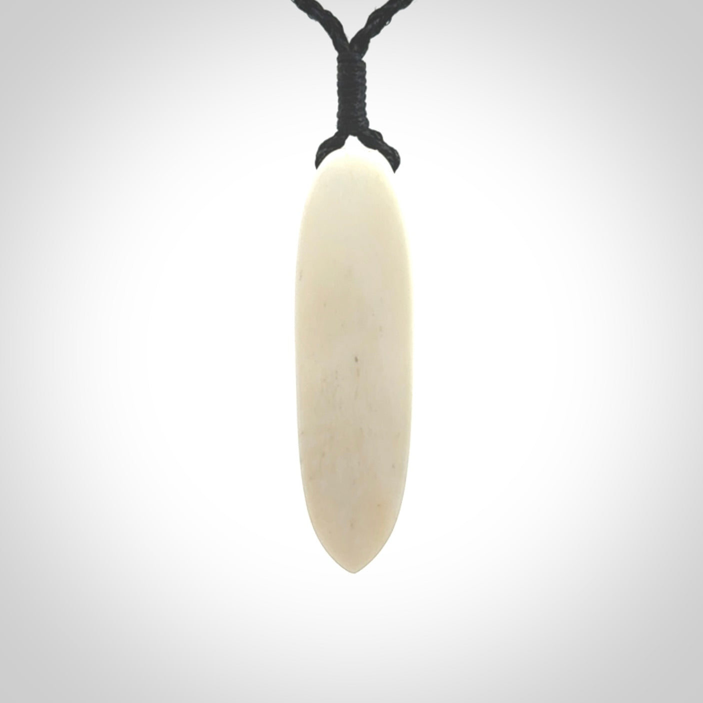 This is a wonderful, finely carved drop pendant. Hand made from bone with copper inlay and delivered to you with an adjustable black cord.
