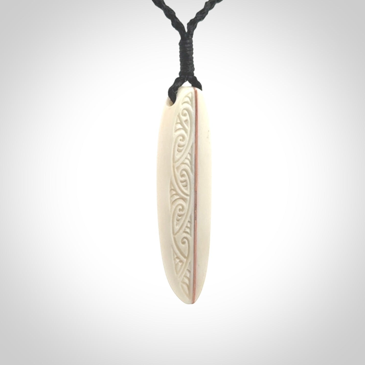 This is a wonderful, finely carved drop pendant. Hand made from bone with copper inlay and delivered to you with an adjustable black cord.
