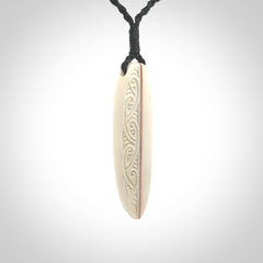 This is a wonderful, finely carved drop pendant. Hand made from bone with copper inlay and delivered to you with an adjustable black cord.