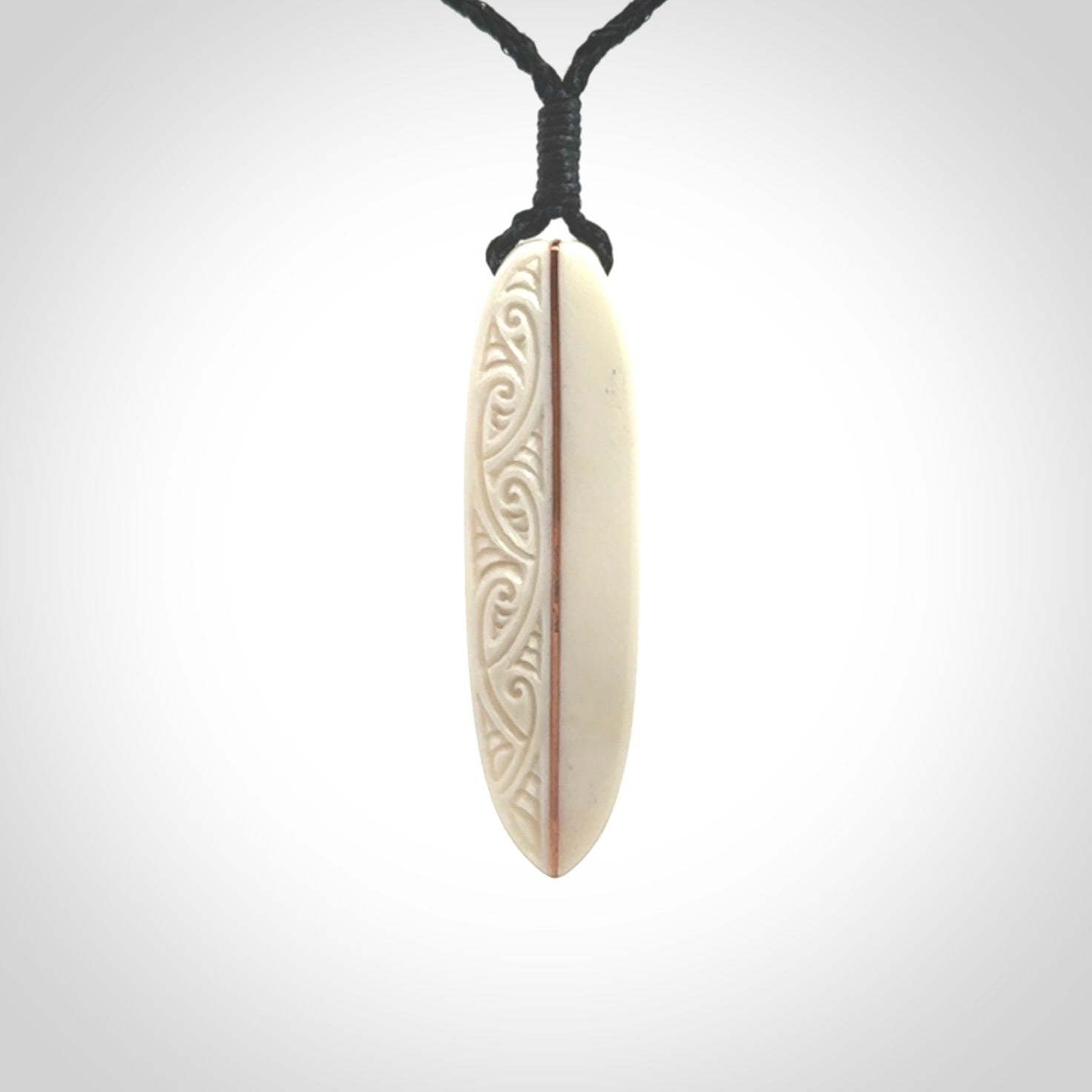 This is a wonderful, finely carved drop pendant. Hand made from bone with copper inlay and delivered to you with an adjustable black cord.
