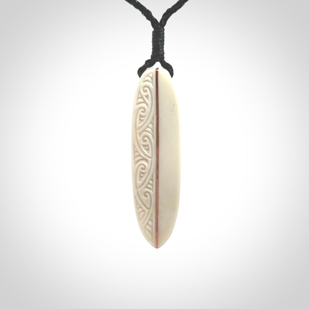 This is a wonderful, finely carved drop pendant. Hand made from bone with copper inlay and delivered to you with an adjustable black cord.