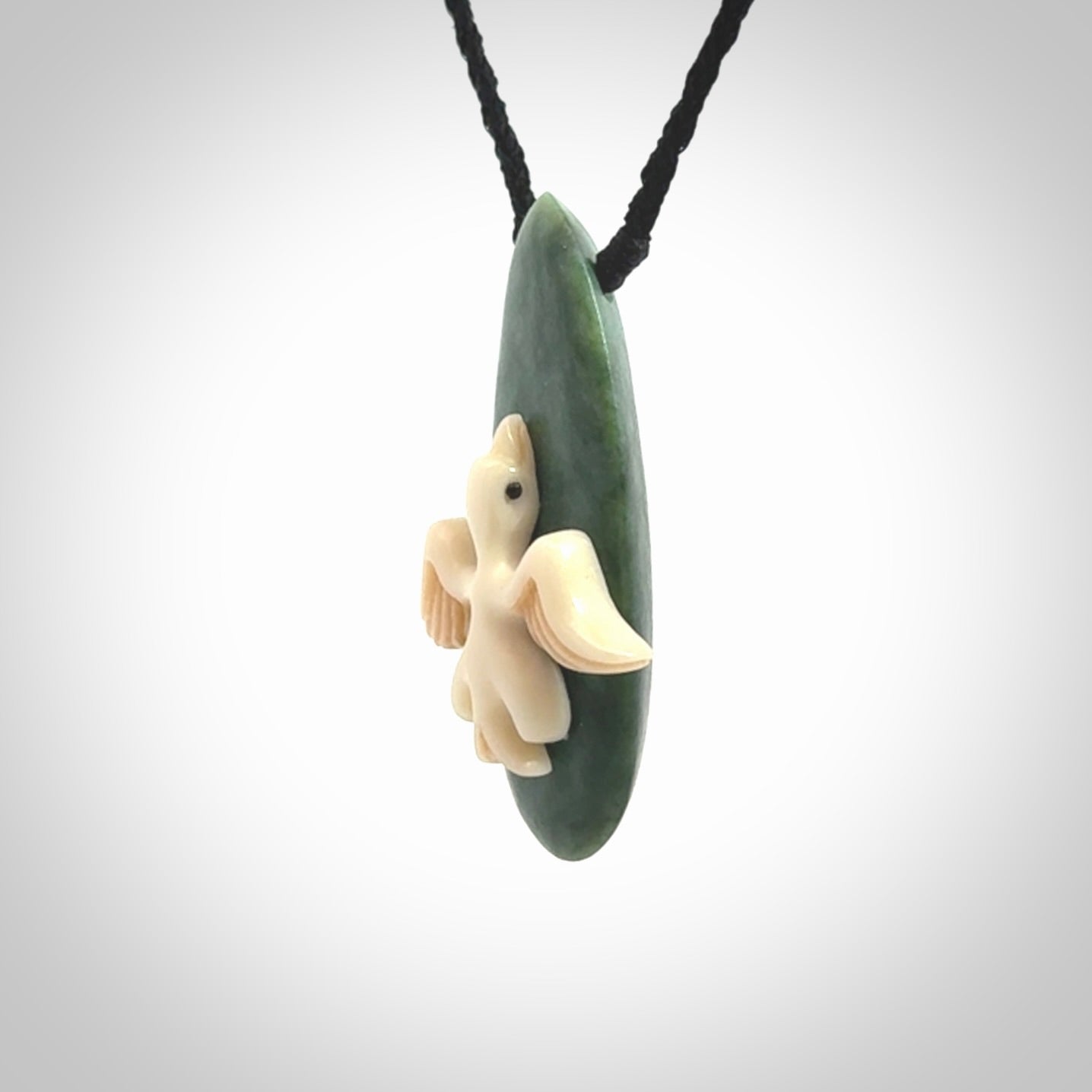 This is a wonderful New Zealand Jade and bone drop pendant with bird carving.