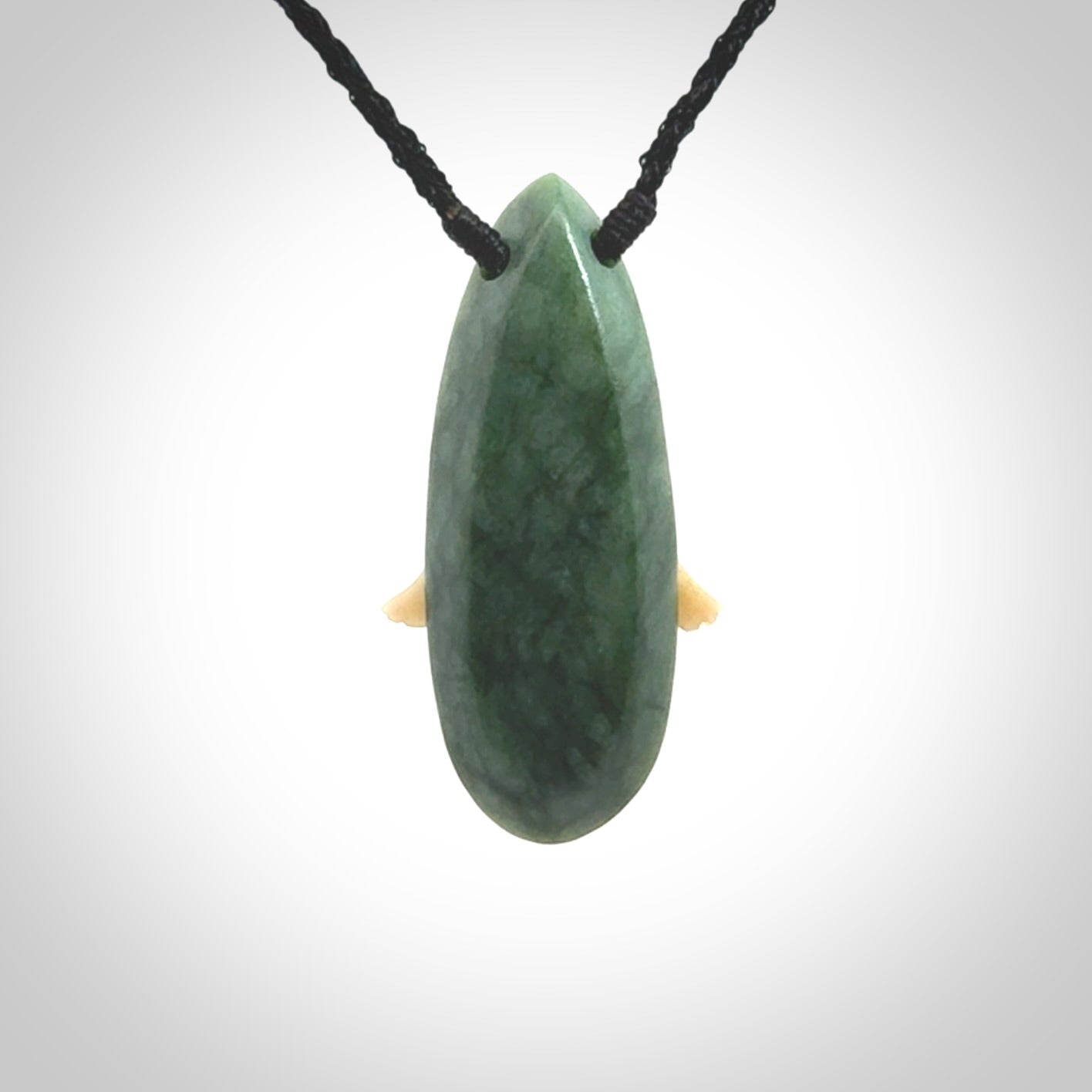 This is a wonderful New Zealand Jade and bone drop pendant with bird carving.