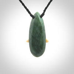 This is a wonderful New Zealand Jade and bone drop pendant with bird carving.
