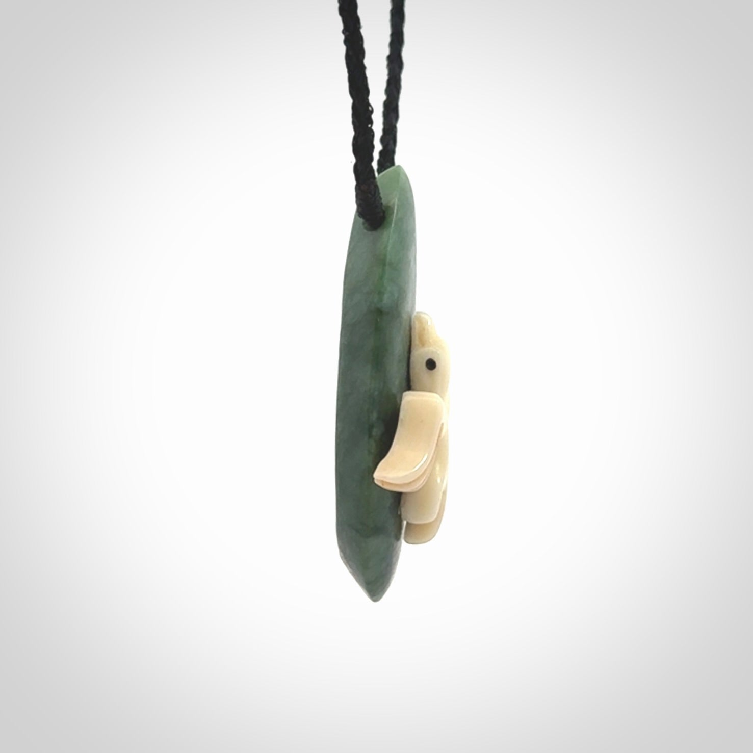 This is a wonderful New Zealand Jade and bone drop pendant with bird carving.