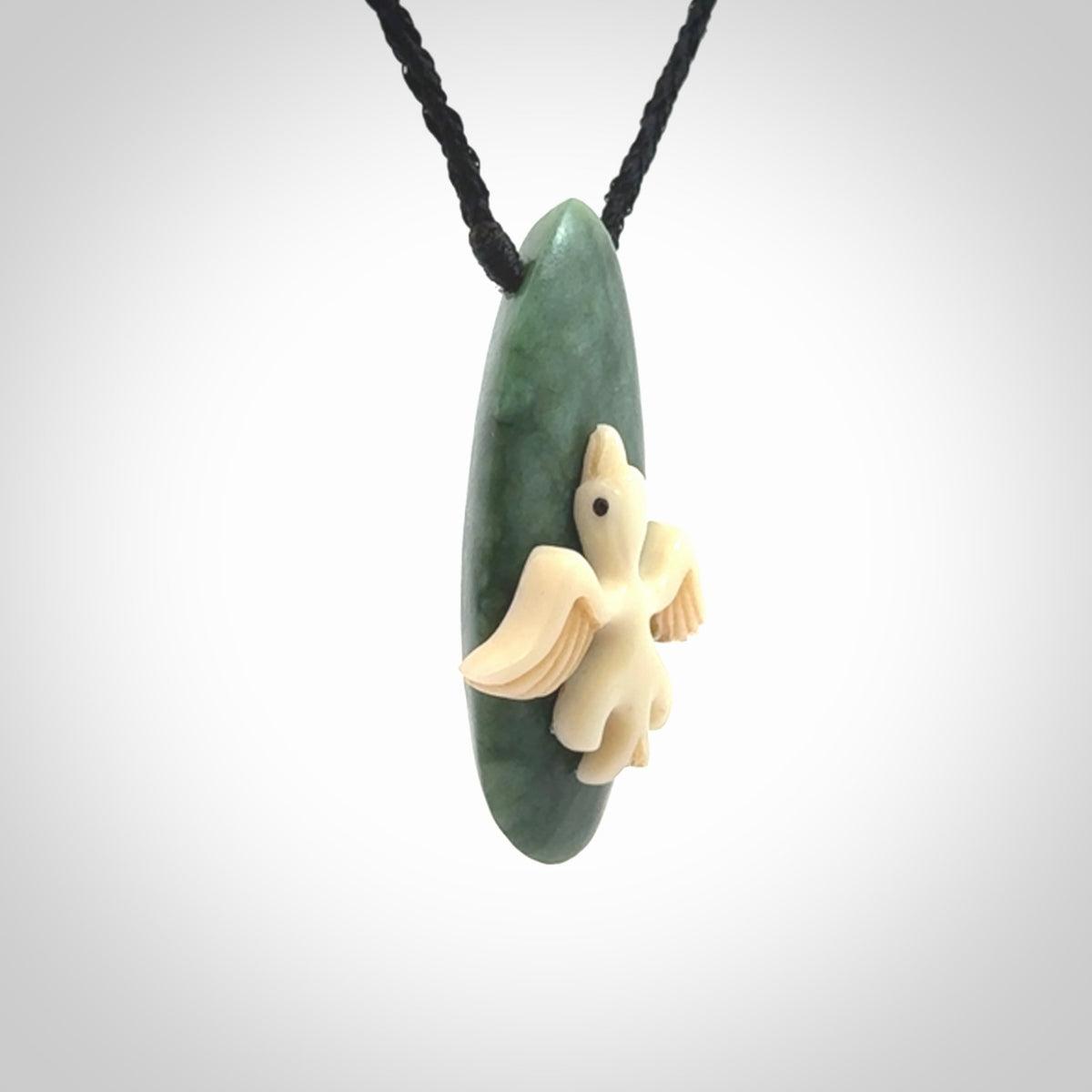 This is a wonderful New Zealand Jade and bone drop pendant with bird carving.