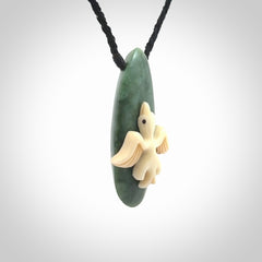This is a wonderful New Zealand Jade and bone drop pendant with bird carving.