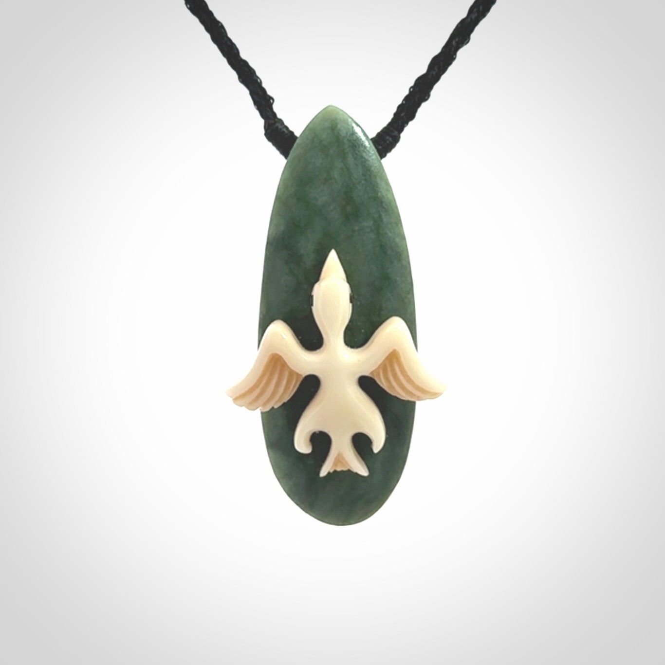This is a wonderful New Zealand Jade and bone drop pendant with bird carving.