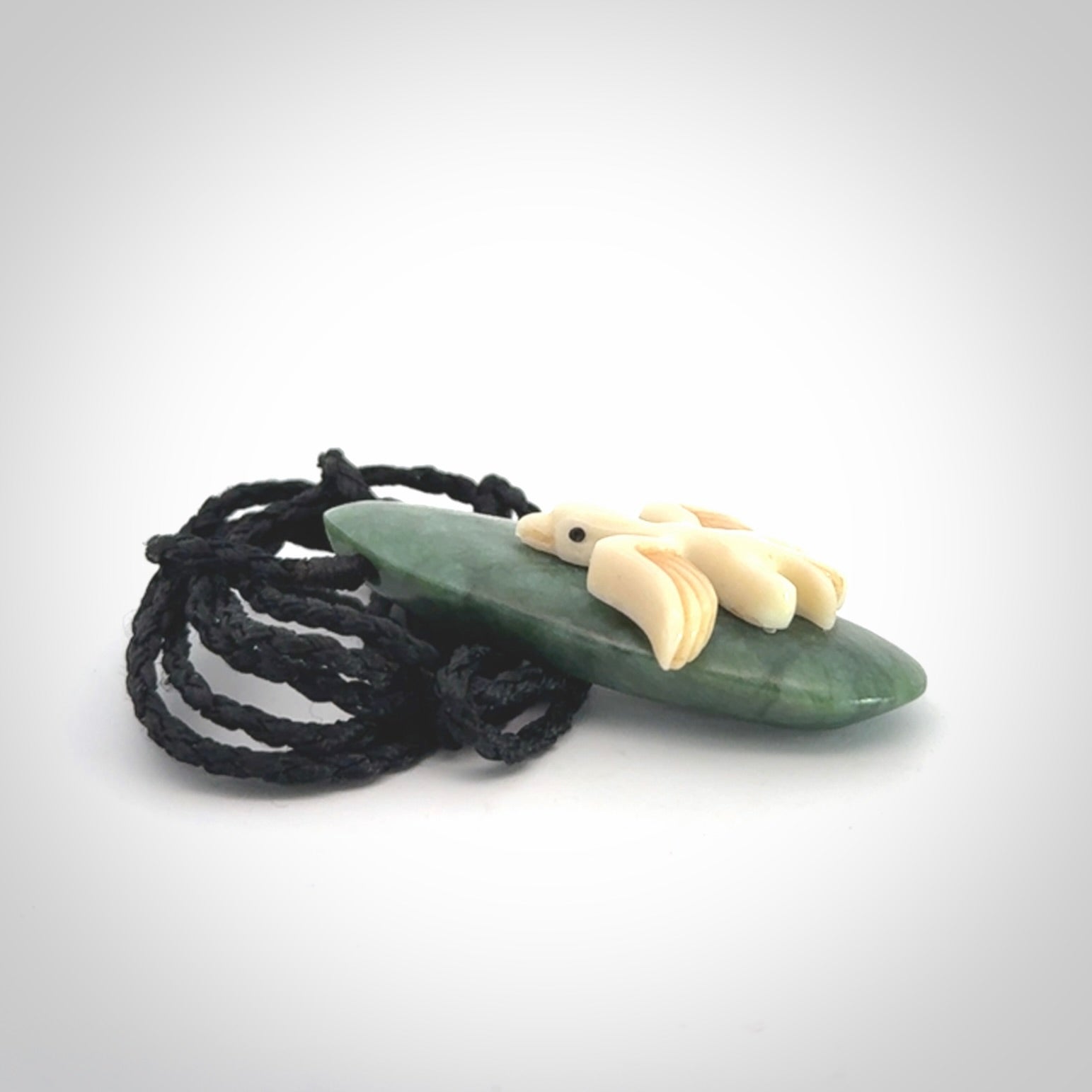 This is a wonderful New Zealand Jade and bone drop pendant with bird carving.