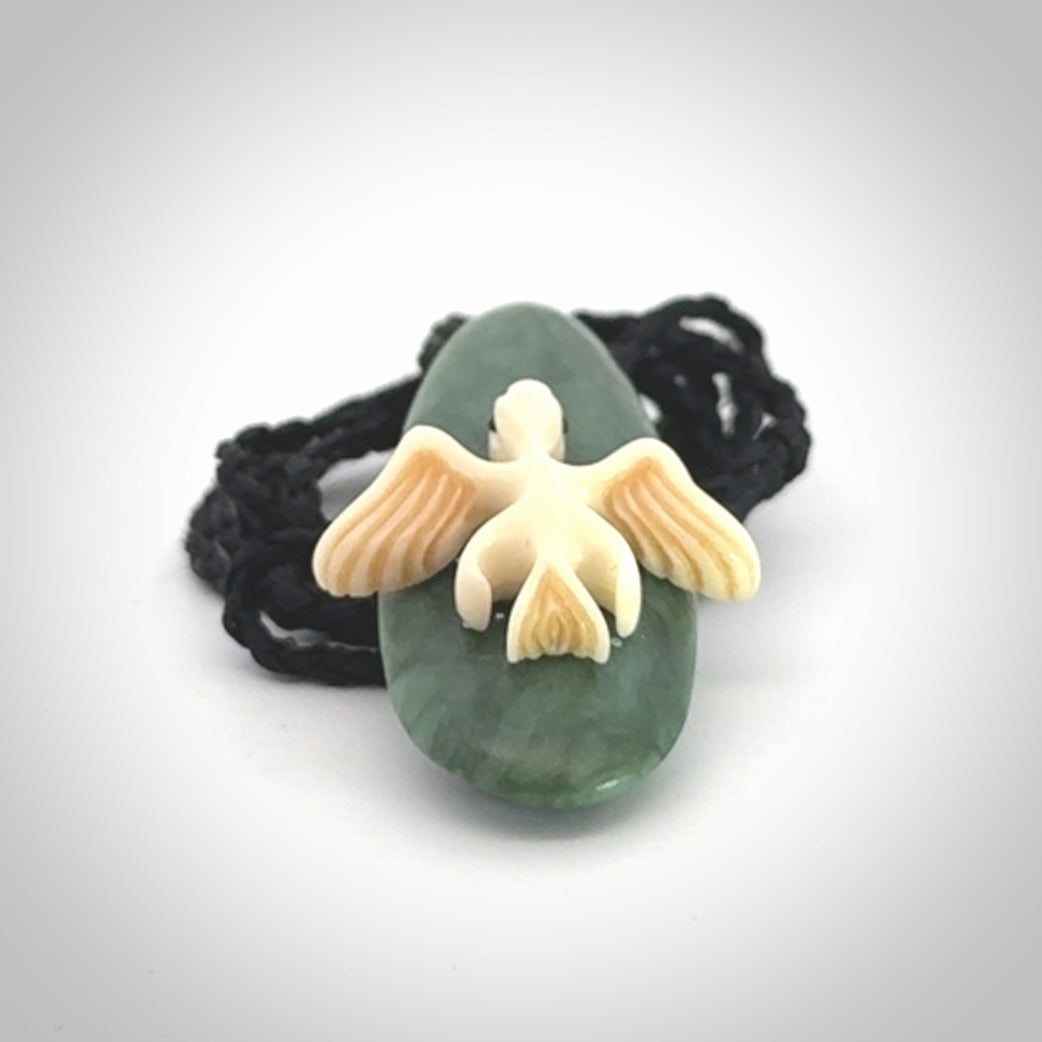 This is a wonderful New Zealand Jade and bone drop pendant with bird carving.