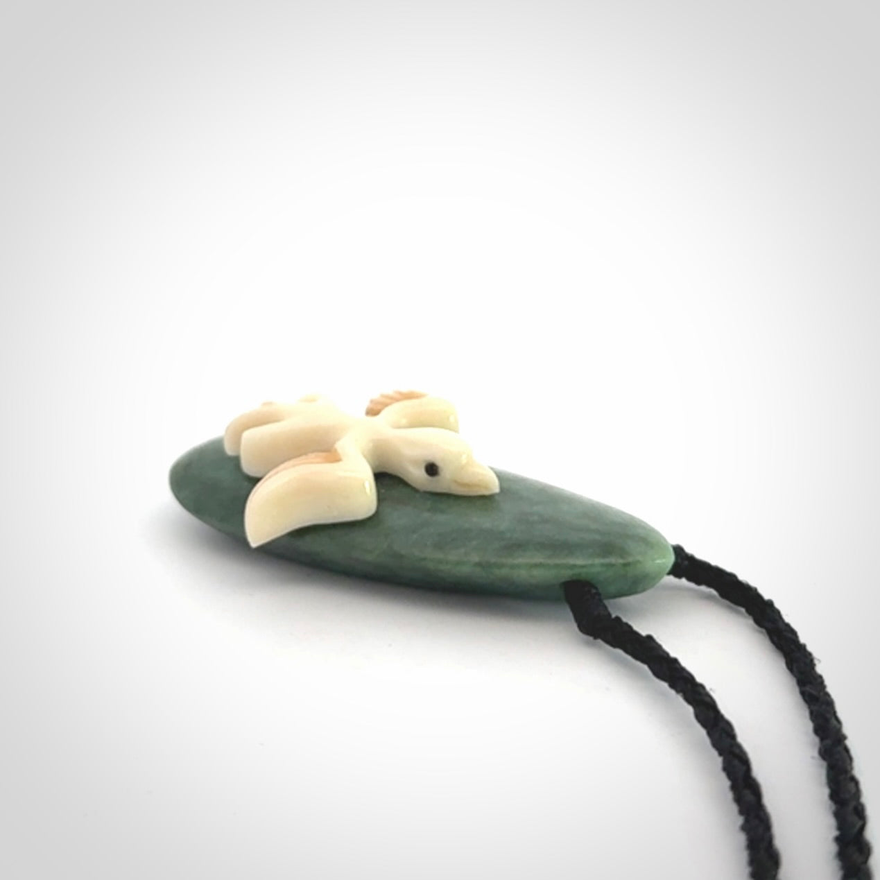 This is a wonderful New Zealand Jade and bone drop pendant with bird carving.