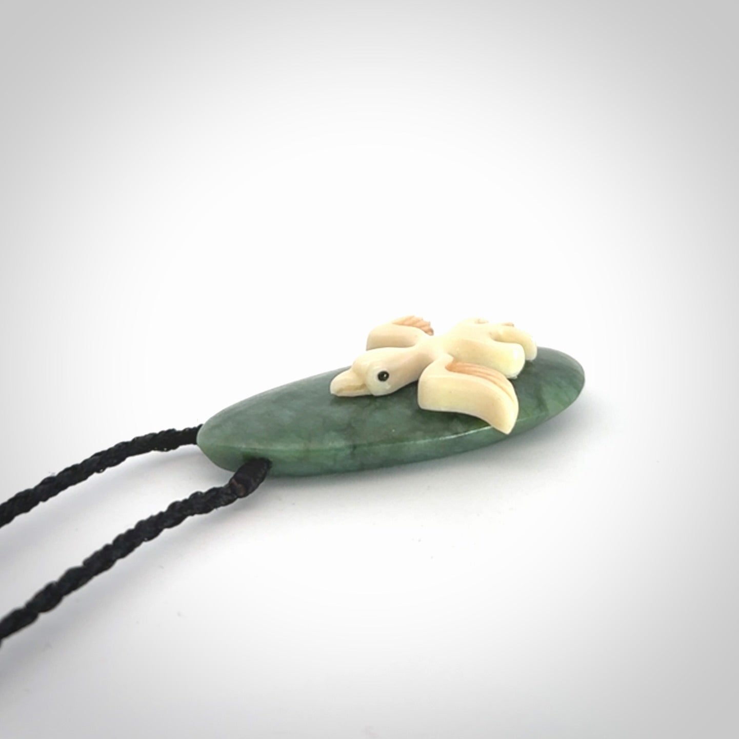 This is a wonderful New Zealand Jade and bone drop pendant with bird carving.