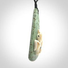 This is a wonderful New Zealand Jade and bone drop pendant with bird carving.