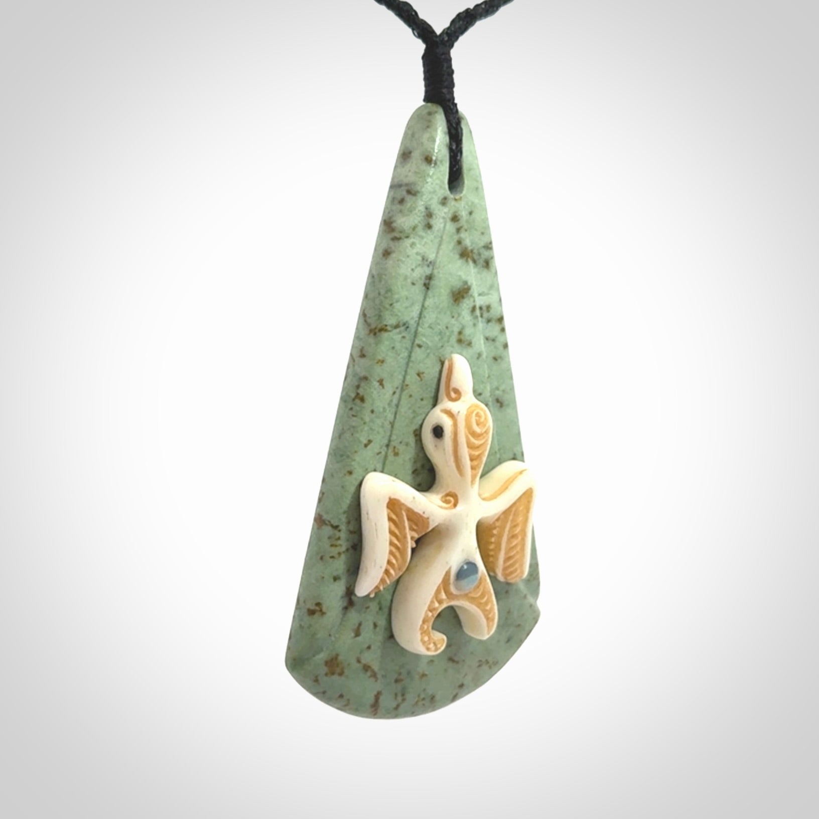 This is a wonderful New Zealand Jade and bone drop pendant with bird carving.