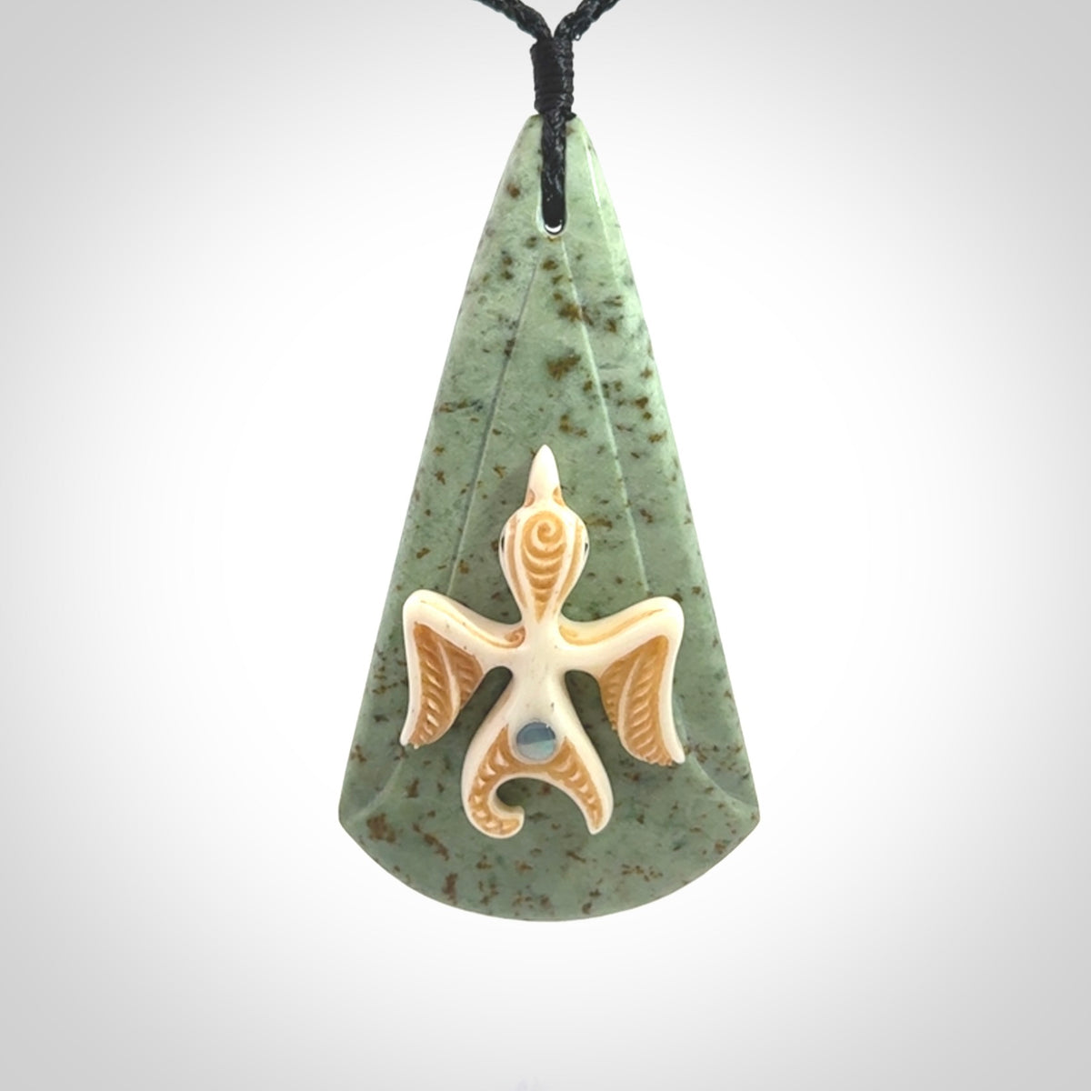 This is a wonderful New Zealand Jade and bone drop pendant with bird carving.