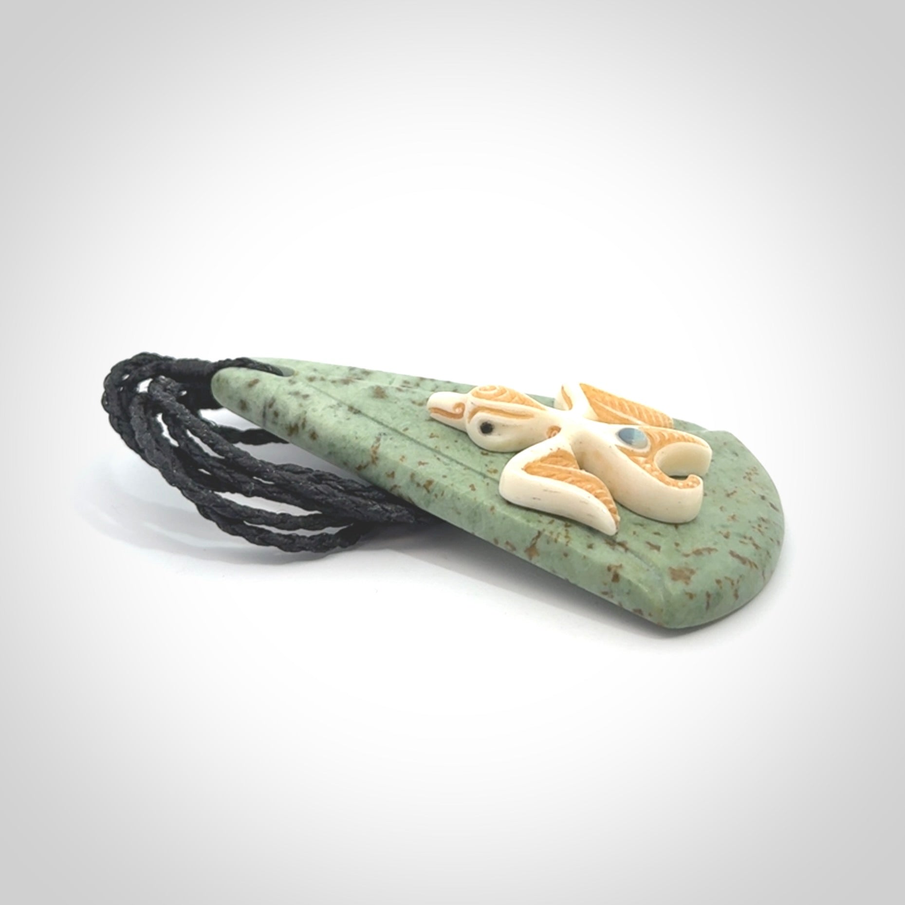 This is a wonderful New Zealand Jade and bone drop pendant with bird carving.