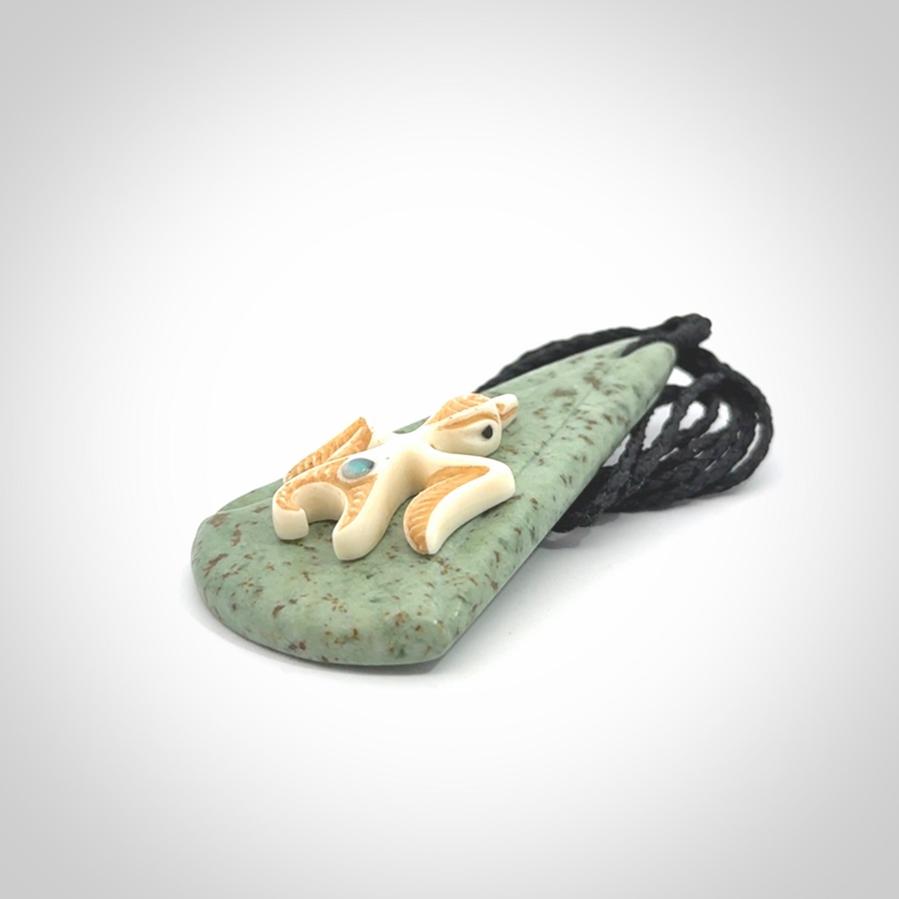 This is a wonderful New Zealand Jade and bone drop pendant with bird carving.