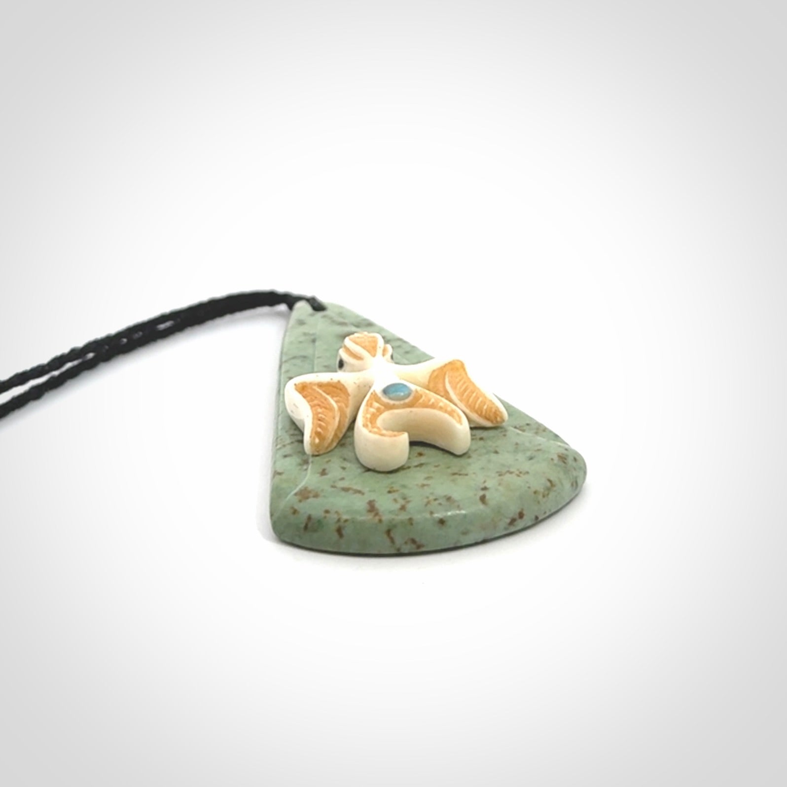 This is a wonderful New Zealand Jade and bone drop pendant with bird carving.