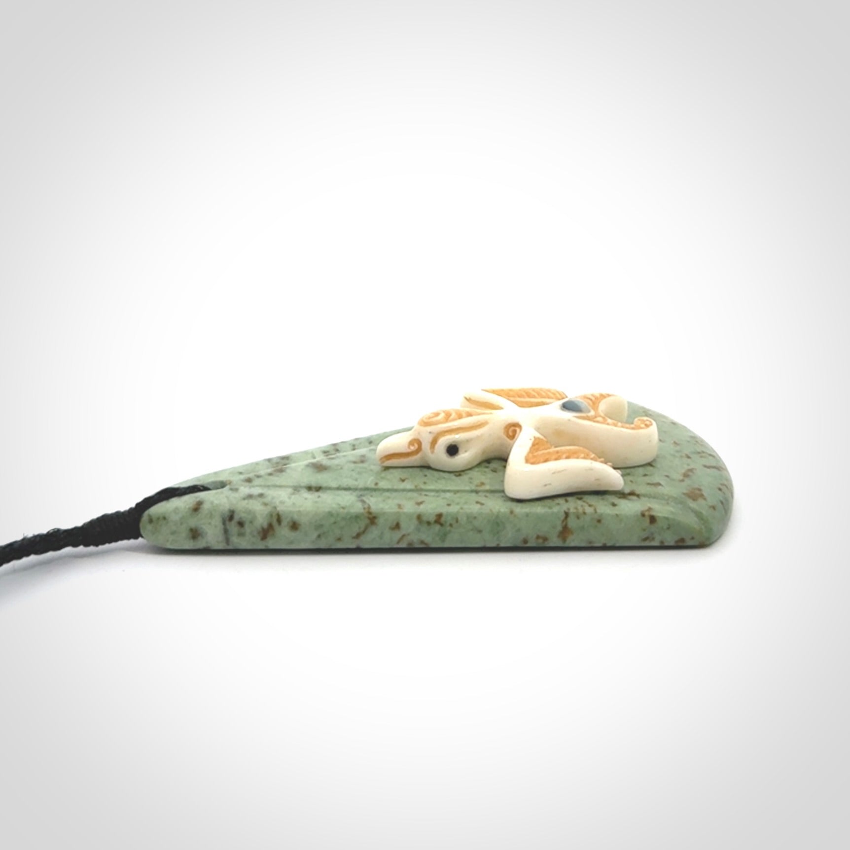 This is a wonderful New Zealand Jade and bone drop pendant with bird carving.