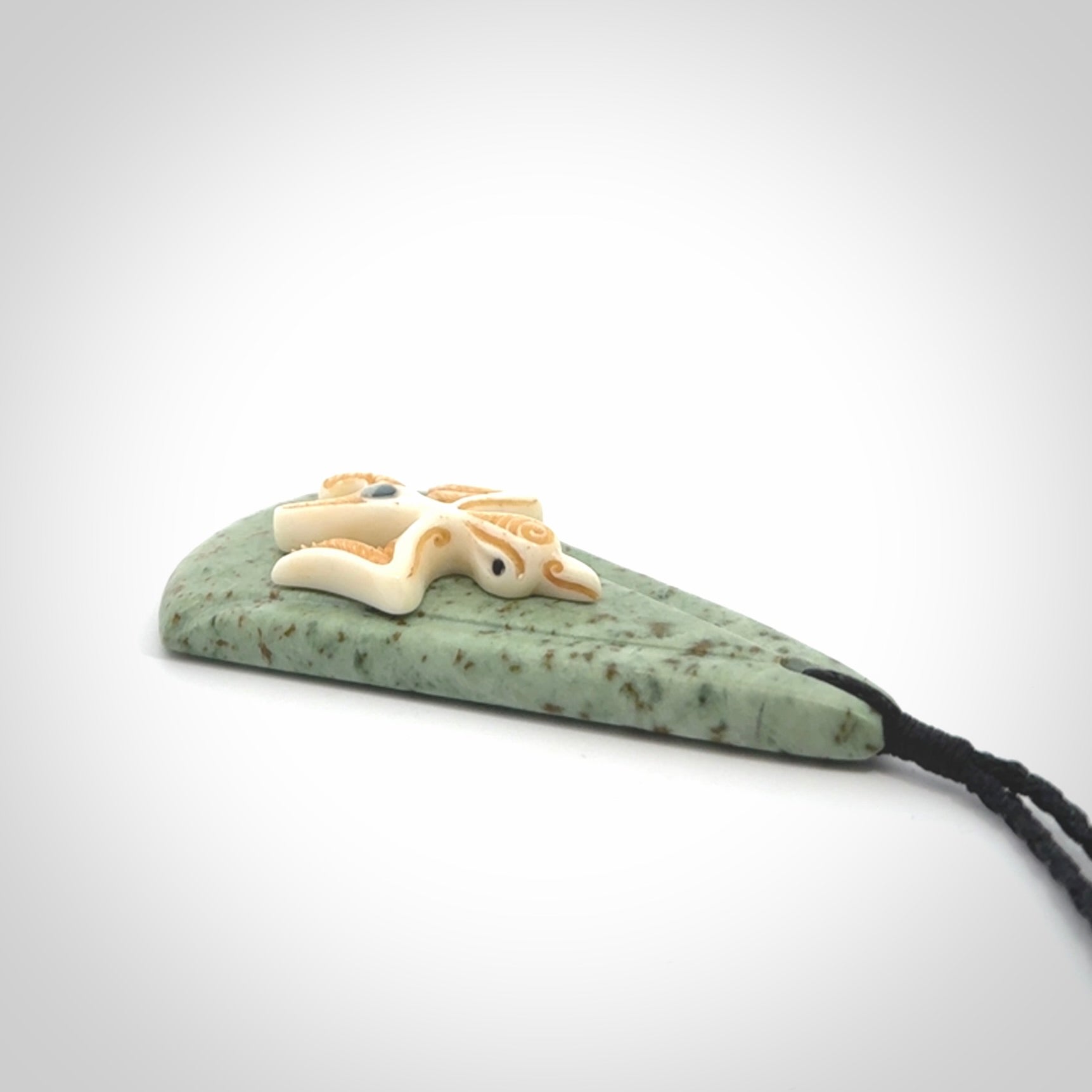 This is a wonderful New Zealand Jade and bone drop pendant with bird carving.