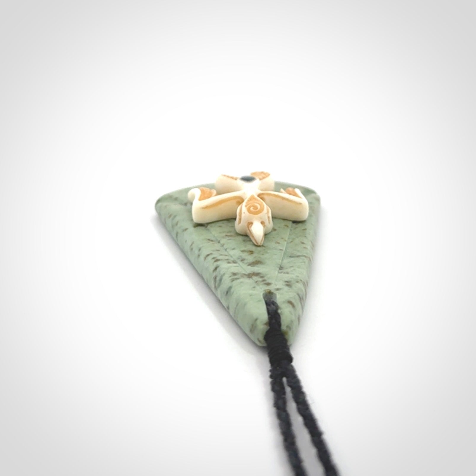 This is a wonderful New Zealand Jade and bone drop pendant with bird carving.